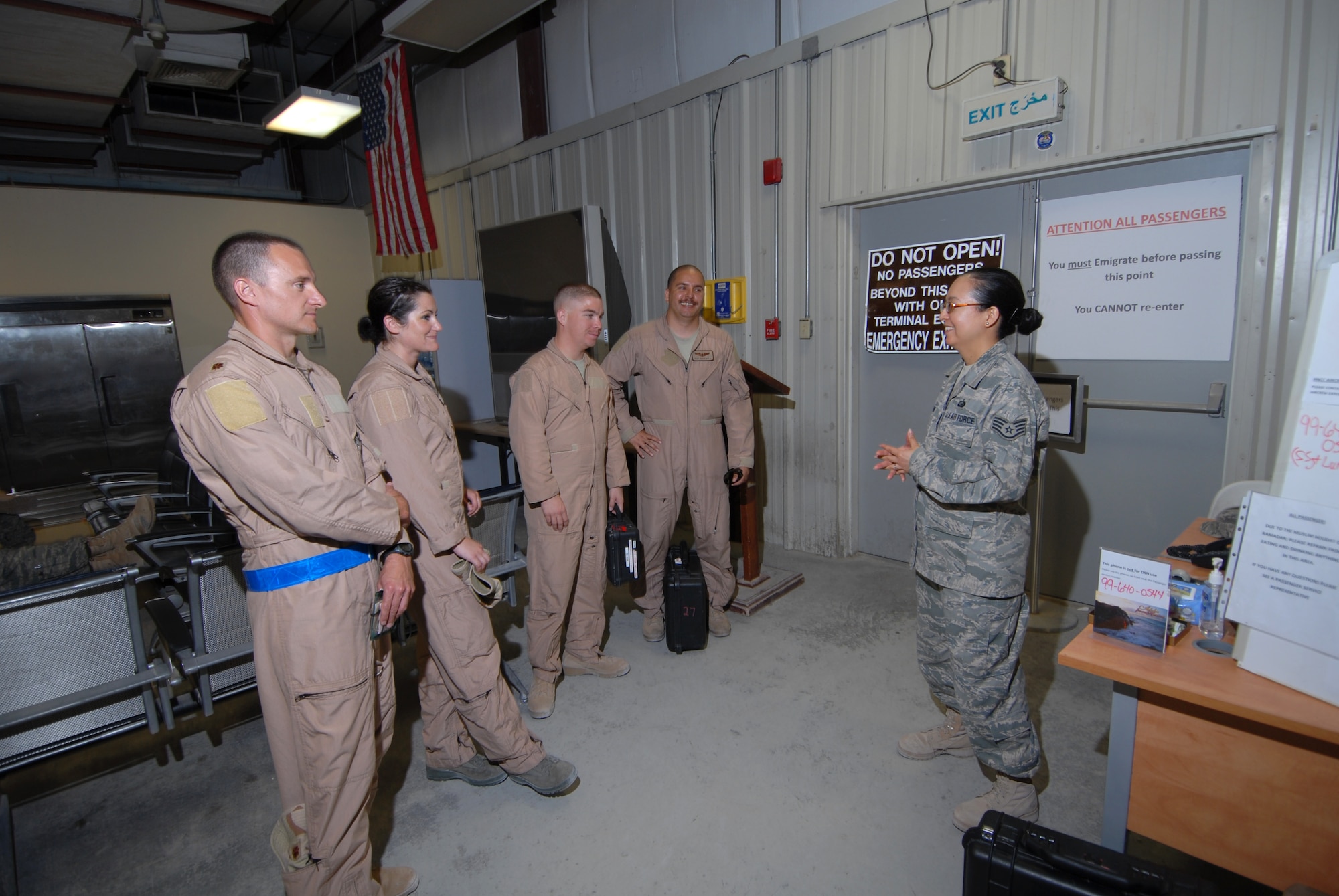 Staff Sgt. Ursula Lund, 379th Air Expeditionary Wing Host Nation Coordination Cell customs and immigration liaison, briefs outbound aircrew members as they immigrate out of the country, here, Sept. 8. The HNCC acts as the liaison between U.S. Armed Forces and the host nation. Sergeant Lund is deployed from the F.E. Warren  Air Force Base, Wyo. in support of Operations Iraqi and Enduring Freedom. (U.S. Air Force Photo/Tech. Sgt. Jason W. Edwards)