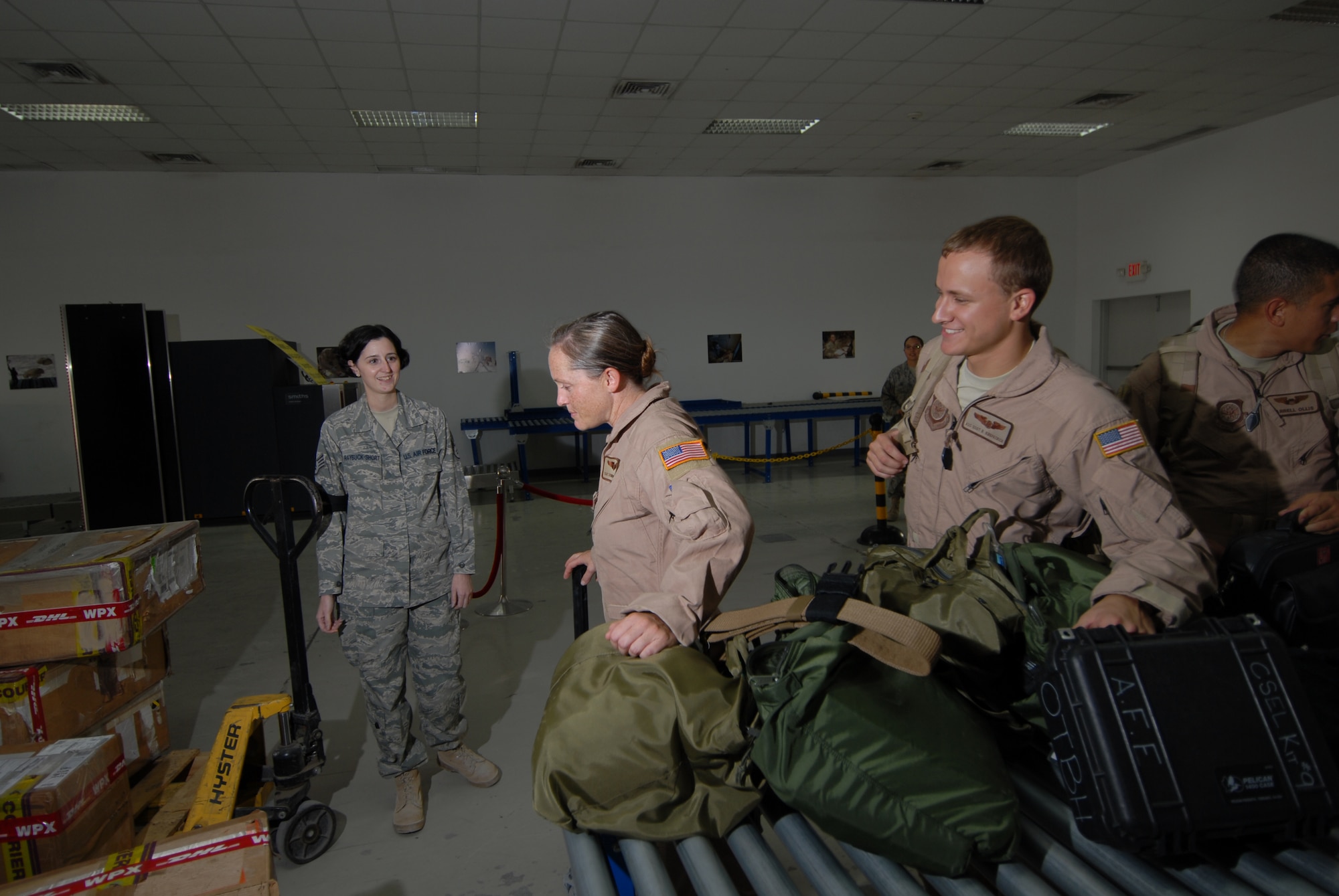 Staff Sgt. Tessa Raybuck-Short, 379th Air Expeditionary Wing Host Nation Coordination Cell customs and immigration liaison, monitors inbound aircrew members as they process through customs, here, Sept. 8. The HNCC acts as the liaison between U.S. Armed Forces and the host nation. Sergeant Raybuck-Short is deployed from Hill Air Force Base, Utah in support of Operations Iraqi and Enduring Freedom.  (U.S. Air Force Photo/Tech. Sgt. Jason W. Edwards)