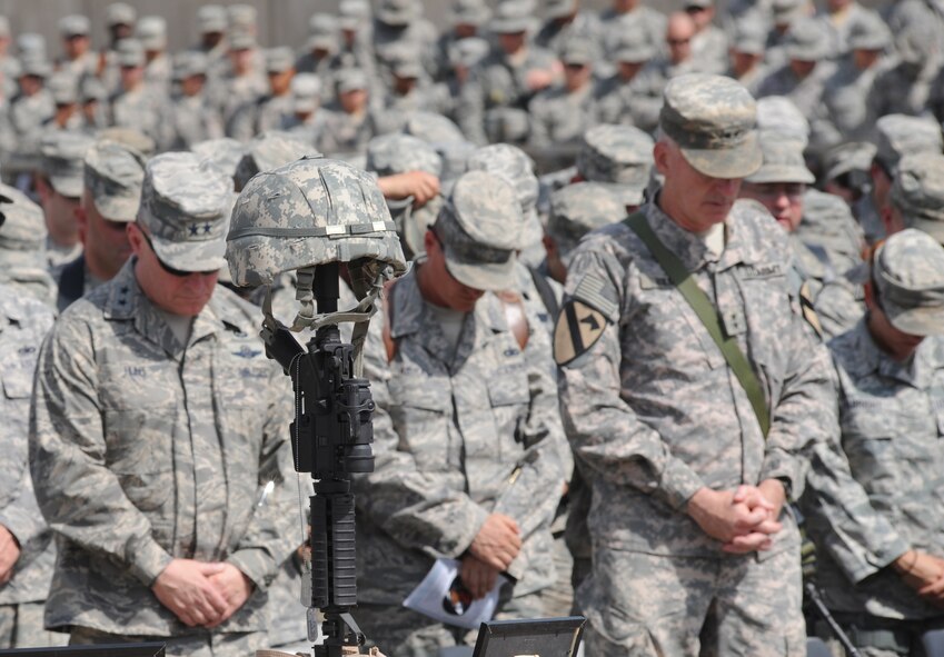 Military members from the Victory Base Complex attend a memorial ceremony held here to honor Air Force 1st Lt. Joseph D. Helton, Jr. at Camp Stryker, Iraq, on Sept. 12, 2009. Lieutenant Helton was a flight commander for the 732nd Expeditionary Security Forces Squadron, Detachment 2 Police Transition Team, and was tragically killed Sept. 8, 2009, by an improvised explosive device while leading his team on a mission in Baghdad. (U.S. Air Force Photo/Tech. Sgt. Johnny L. Saldivar) 