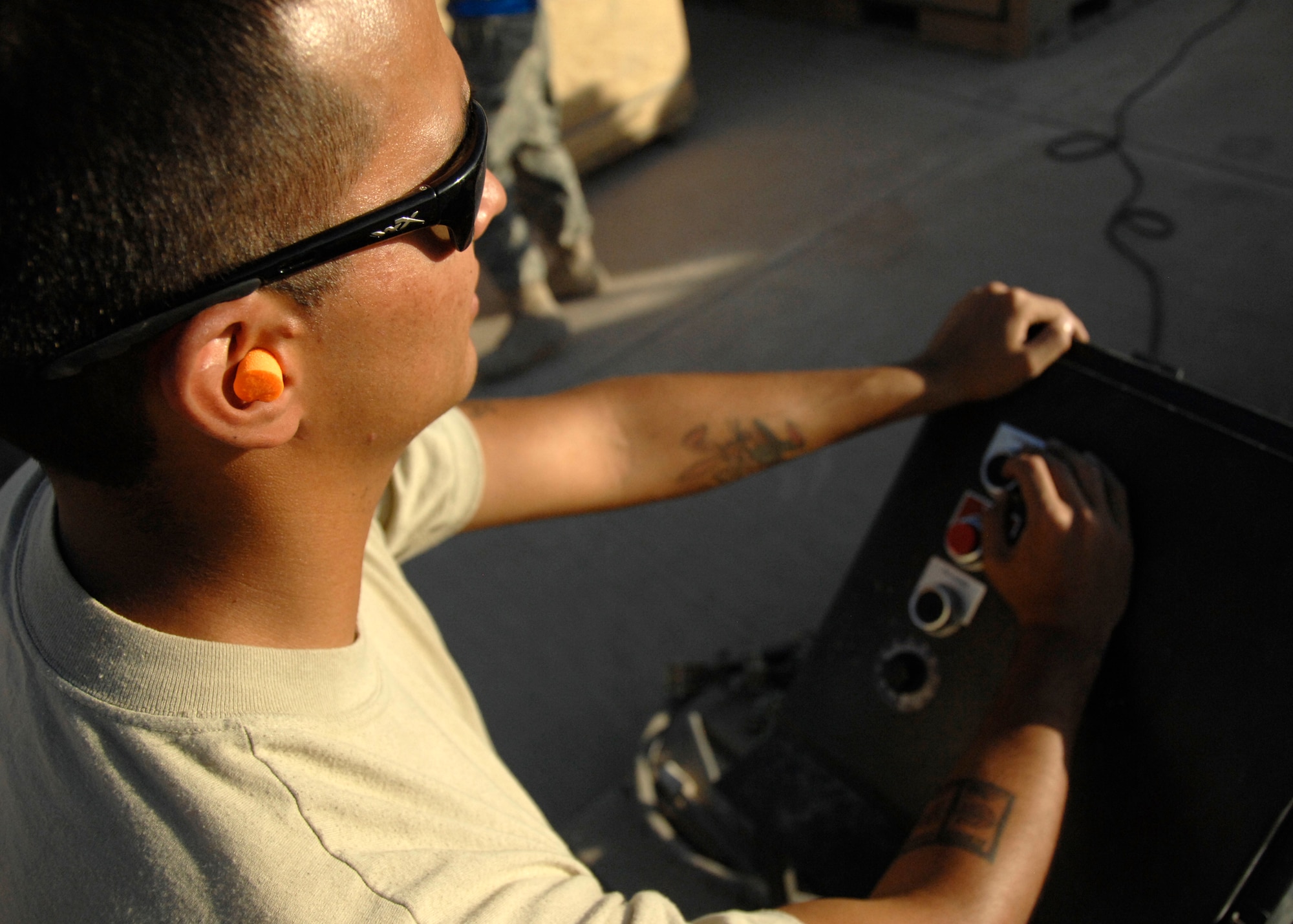 Airman 1st Class Daniel Simonton controls the ammunition loading assemply by control panel while other Airmen feed and store 30mm shells here, Sept. 15, 2009. Currently the A-10 Thunderbolt and GAU-8 gatling gun use the the 30mm shells. Airman Simonton is a Munitions Crew member with the 451st Expeditionary Maintenance Squadron from Davis-Mothan Air Force Base and hails from Sahurita, Ariz. (U.S. Air Force photo/Senior Airman Timothy Taylor)