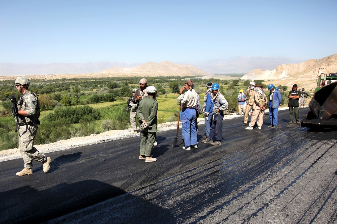 U.S. Army soldiers and Air Force airmen visit a road construction site in Mahmood Rahqi, Afghanistan, Sept. 9, 2009.