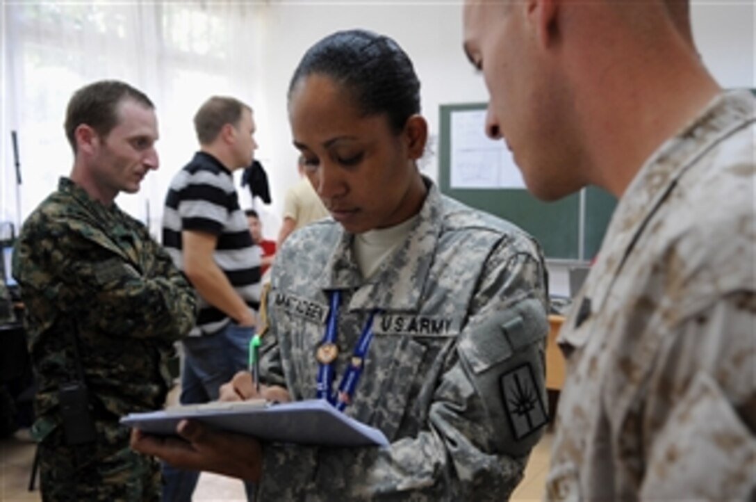 U.S. Army Spc. Judy Mattadeen, of the 101st Signal Battalion, Yonkers, N.Y., verifies linked communications between high-frequency radios being tested at Kozara Barracks, Banja Luka, Bosnia-Herzegovina, during Combined Endeavor 2009 on Sept. 9, 2009.  Combined Endeavor, sponsored by Headquarters, U.S. European Command, is a communications and information systems interoperability test among Partnership for Peace participants, NATO members and other nations that focuses on planning processes, communications information systems and human interoperability and the development of a road map for future improvement among participants.  