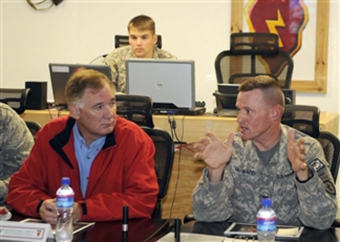 Deputy Secretary of Defense William J. Lynn III talks with Col. Michael Howard, U.S. Army, while visiting Field Operation Base Salerno in Afghanistan on Sept.10, 2009.   