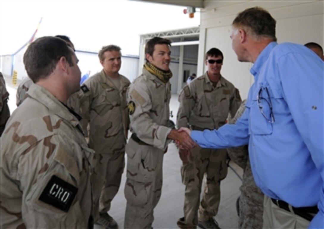 Deputy Secretary of Defense William J. Lynn III greets Air Force pararescue jumpers while touring a Role 3 hospital in Bastion, Afghanistan, on Sept.10, 2009.  