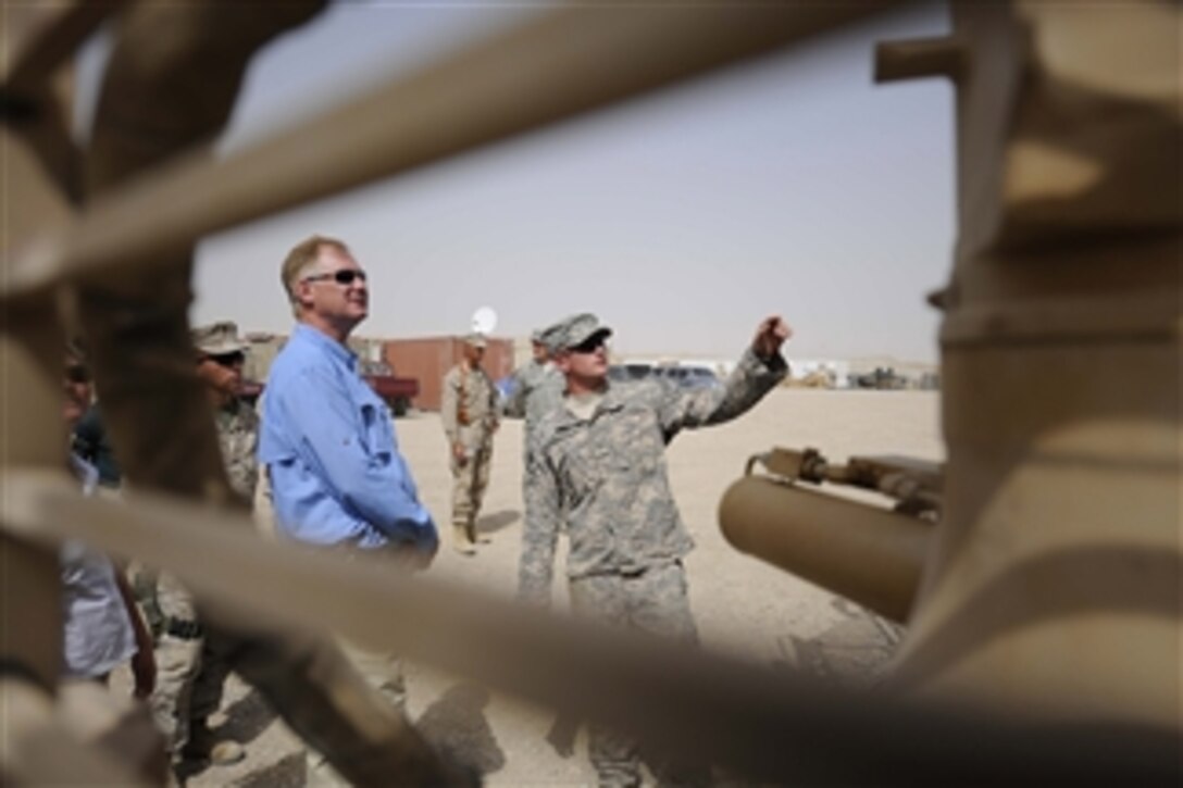 Deputy Secretary of Defense William J. Lynn III receives a tour of Mine Resistant Ambush Protected vehicles at Camp Leatherneck, Afghanistan, on Sept.10, 2009.  
