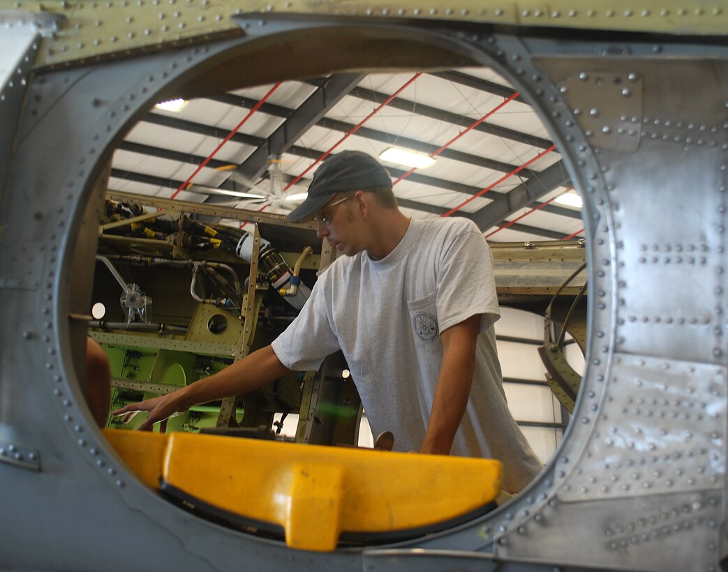 Kenny Ausdemore, sheet metal mechanic, reinforces the frame of an AV-8B Harrier in the Fleet Readiness Center hangar at the Marine Corps Air Station in Yuma, Ariz., Sept. 16, 2009. The FRC performs preventative maintenance inspections, as well as major modifications to structural and electrical systems on aircraft beyond what a squadron’s maintenance personnel are trained to do. The thirty-man crew is scheduled to work more than 48,000 hours this year.