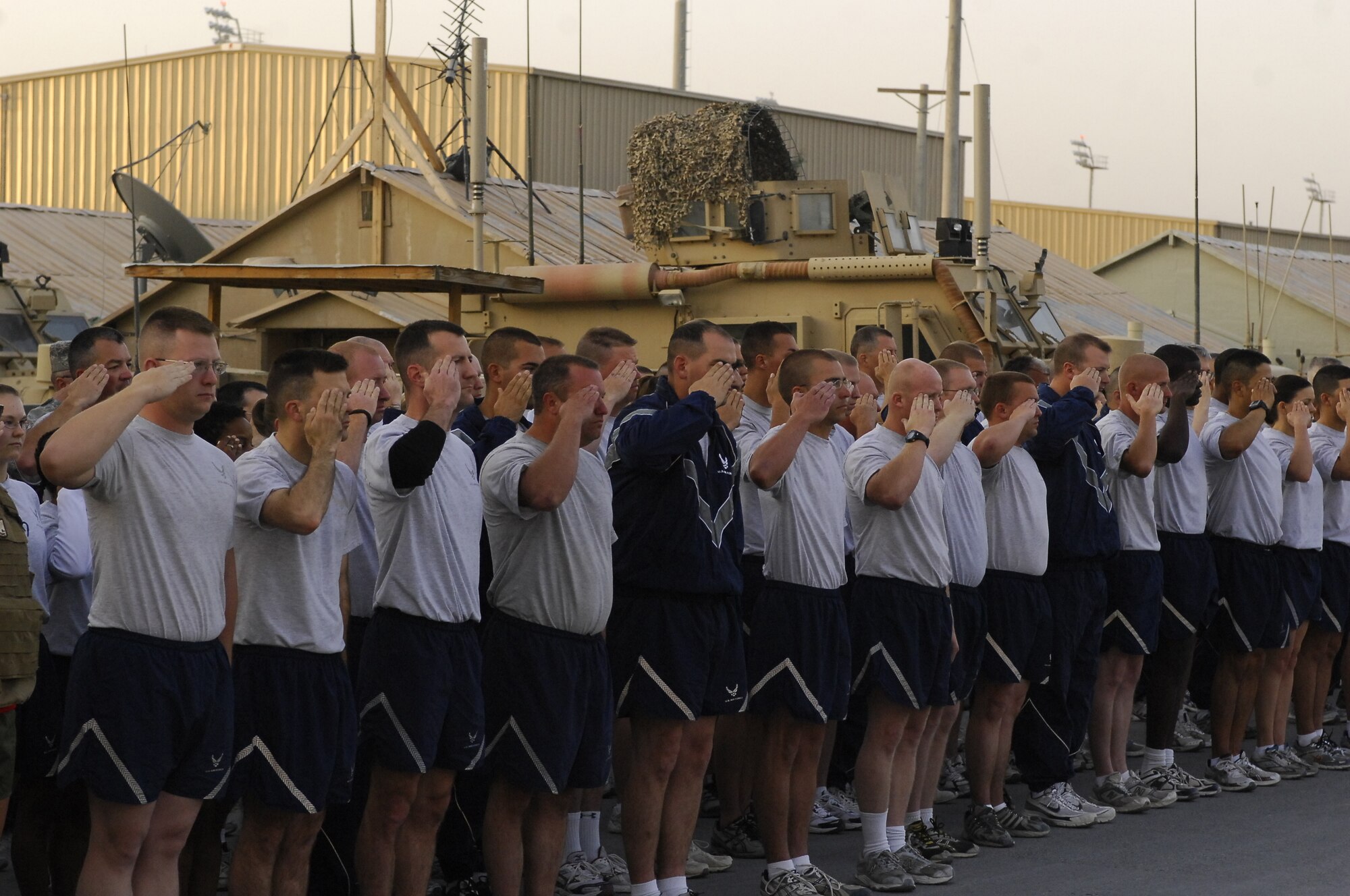 BAGRAM AIRFIELD, Afghanistan -- Several hundred Airmen salute as the U.S. flag is raised at 6 a.m., at Camp Cunningham here on the 62nd Air Force Birthday, Sept. 18, 2009. The Airmen ran a five kilometer run afterwards to show their strength and determination to continue taking the fight to the enemy everyday. (U.S. Air Force photo/Senior Airman Felicia Juenke)