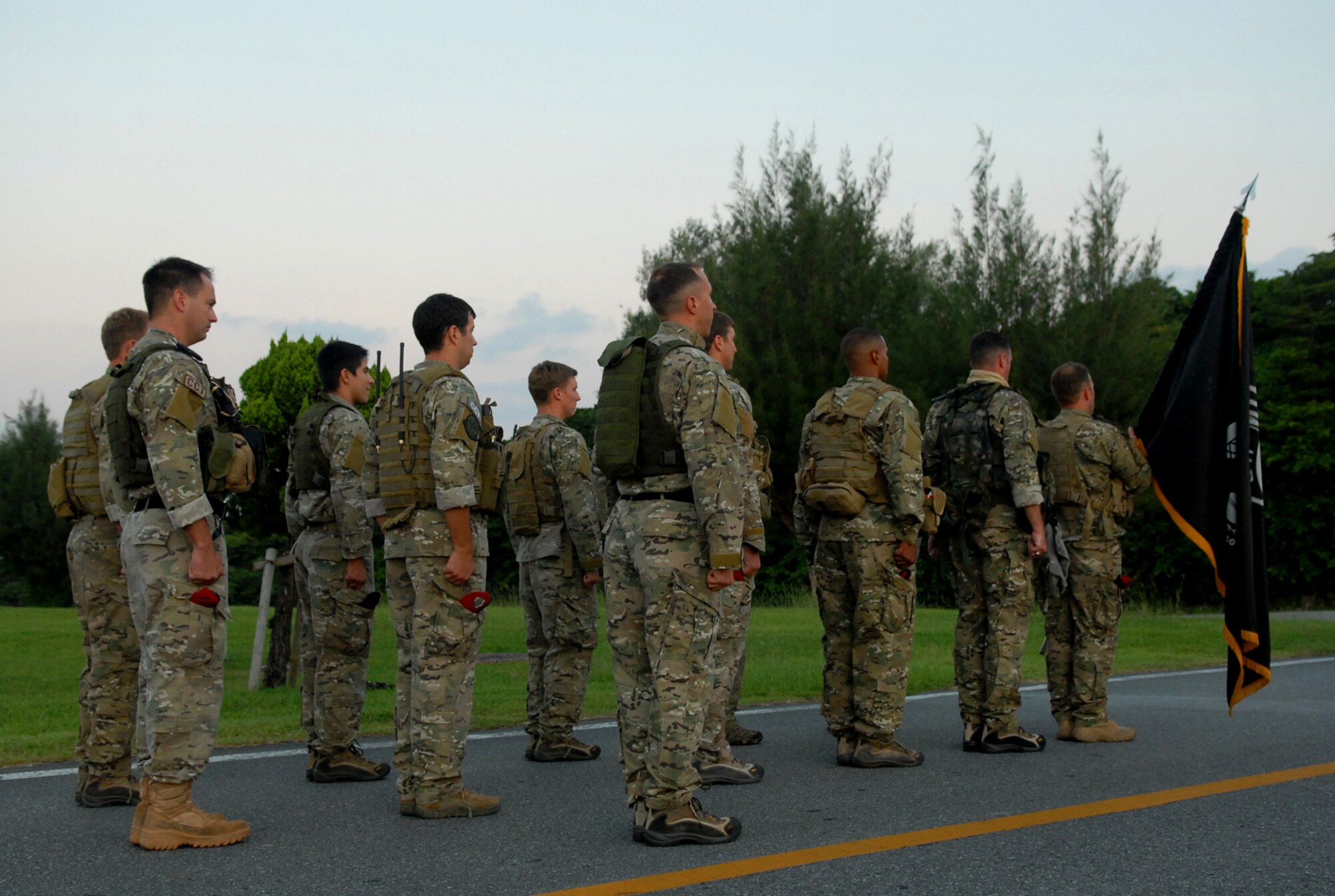 A formation of Special Forces Airmen prepare to carry the POW/MIA flag during the final leg of the POW/MIA vigil run which was at Kadena from 6 a.m. Sept. 17 to 6 a.m. Sept. 18. The run concluded with the flag being taken to the wing headquarters where it was raised during a ceremony which honored the sacrifices of our prisoners and missing. (U.S. Air Force photo/Staff Sgt. Christopher Hummel)