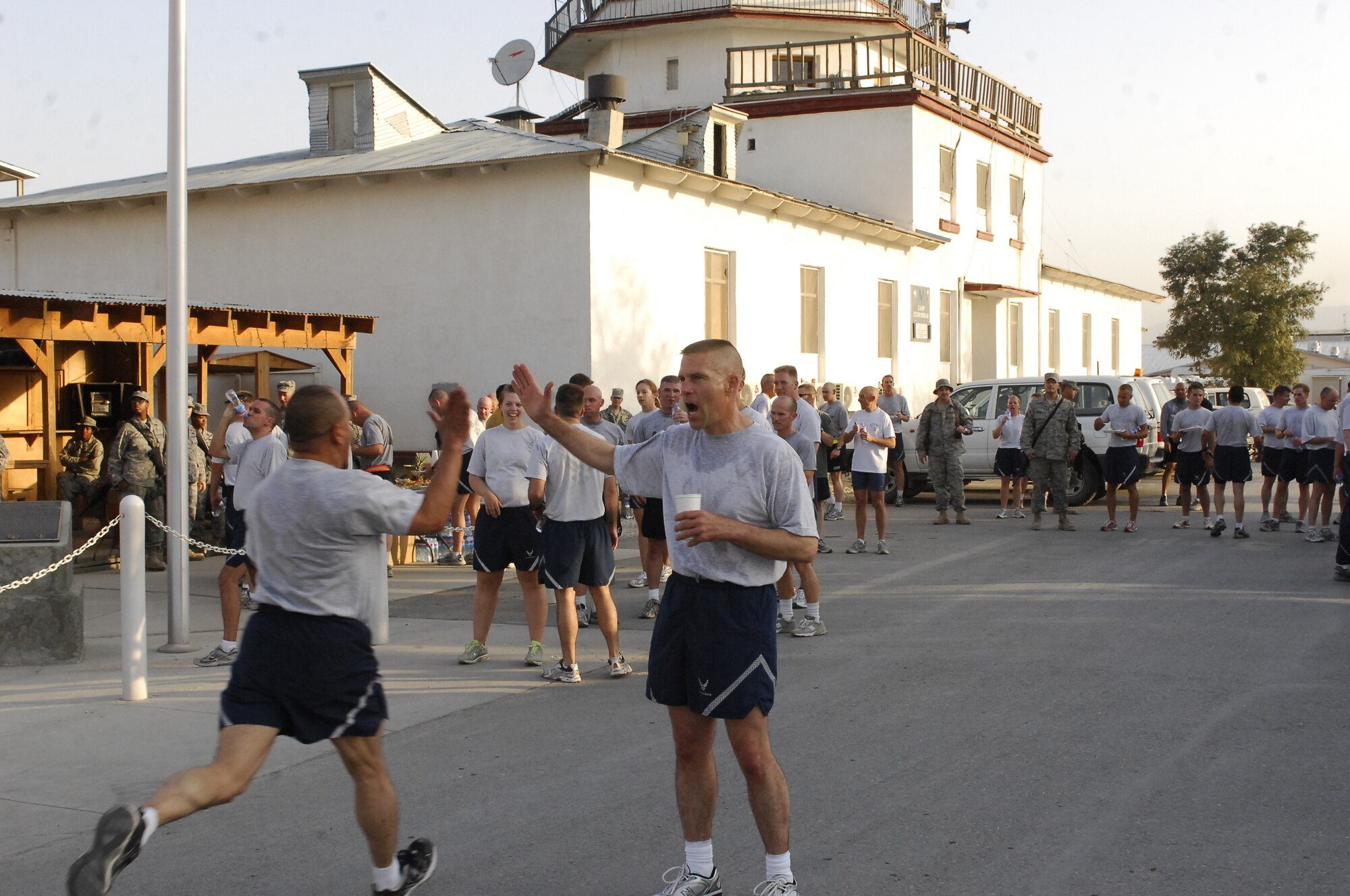 BAGRAM AIRFIELD, Afghanistan -- Brig. Gen. Steven Kwast encourages an Airman to 'finish strong' as he completes a five kilometer run on the 62nd Air Force Birthday here Sept. 18, 2009.  Airmen here were challenged by the general to run for a month leading up to the Air Force Birthday and then run the five kilometer run with him after a reveille ceremony to complete the challenge. (U.S. Air Force photo/Senior Airman Felicia Juenke)