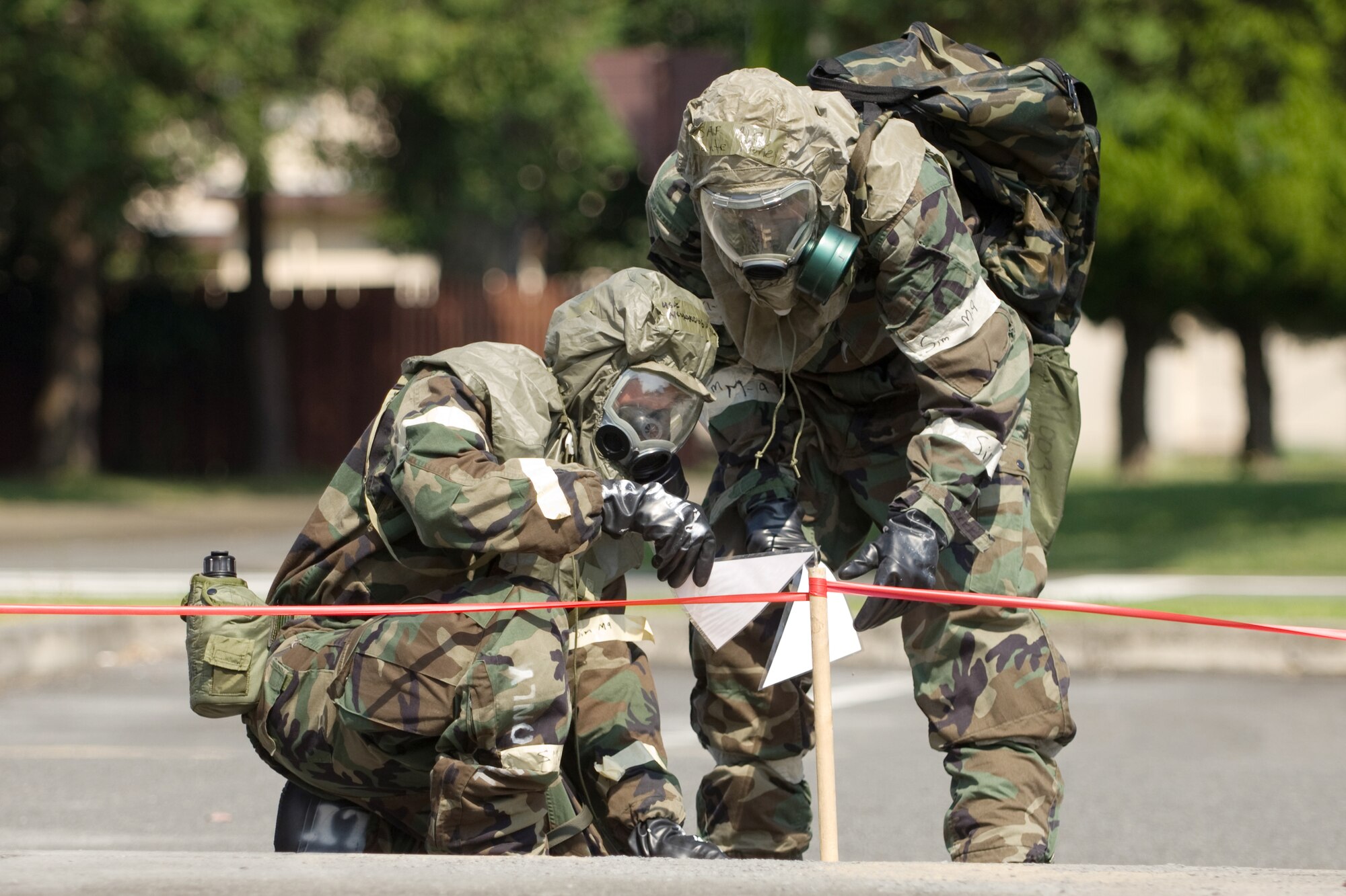 YOKOTA AIR BASE, Japan -- Airman 1st Class Francis Lapinig (left) and Airman 1st Class Dante Money, 374th Security Forces Squadron, set up an unexploded ordnance cordon during an Ability to Survive and Operate Rodeo PAR team competition Sept. 17 at the Taiyo Community Center. Post attack reconnaissance teams from throughout the base went head-to-head to see who was best. The 374th Logistics Readiness Squadron won the competition. The ATSO Rodeo covered areas of emphasis such as contamination control, unexploded ordnance identification and marking and asset protection in a chemical environment. (U.S. Air Force photo/Osakabe Yasuo)
