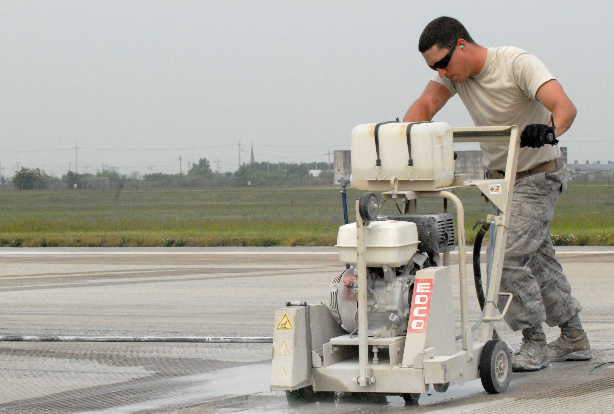 Staff Sgt. Ben Bagnato, 51st Civil Engineer Squadron, repairs a small portion of the eastern side of the Osan Air Base flightline Sept. 17. Sergeant Bagnato and other 51st CES personnel are teaming with local contractors to complete major repairs during a two-week shutdown of the flightline. (U.S. Air Force photo by 1st Lt. Chris Hoyler)