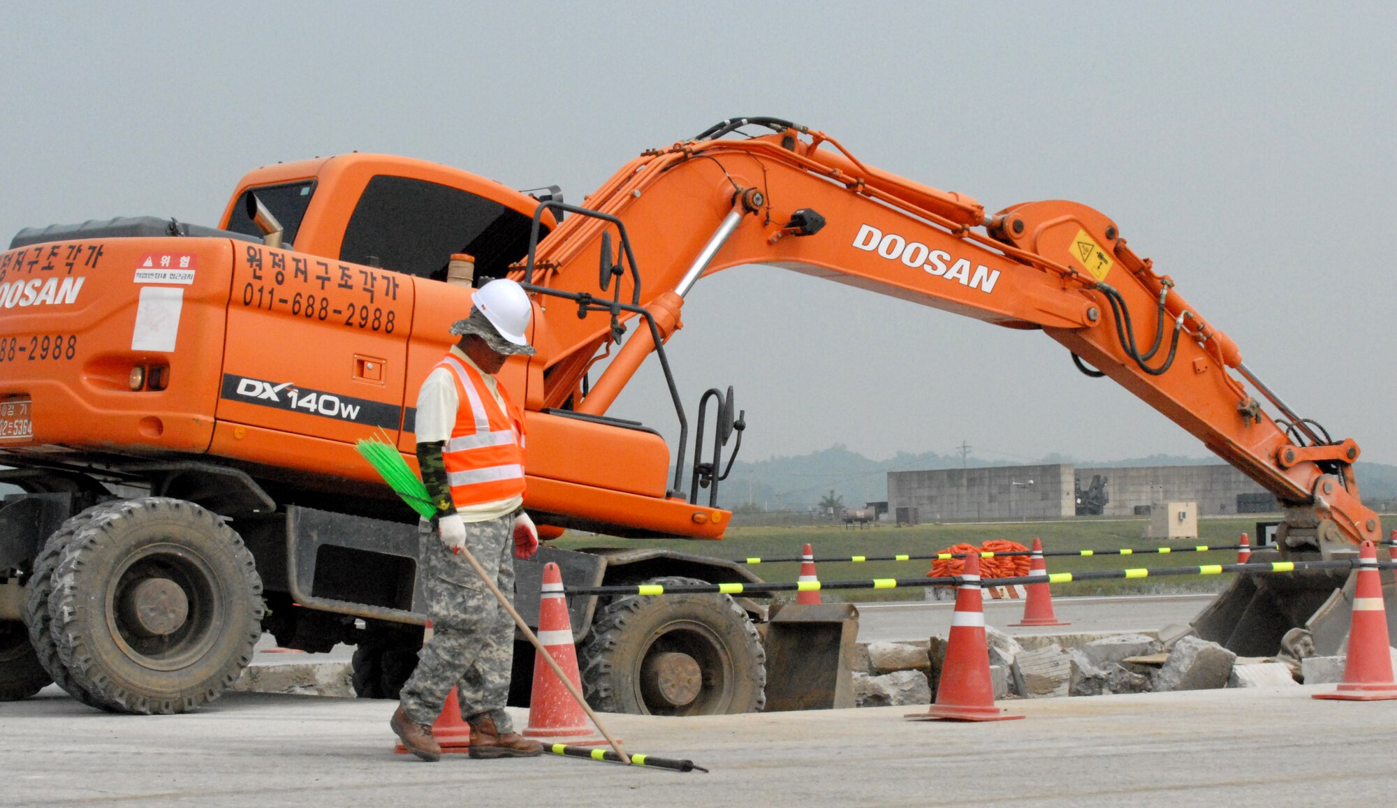 Contracted personnel from the Republic of Korea repair a large piece of the Osan Air Base flightline Sept. 17. The runway is scheduled to be closed for two weeks for major repairs. (U.S. Air Force photo by 1st Lt. Chris Hoyler)