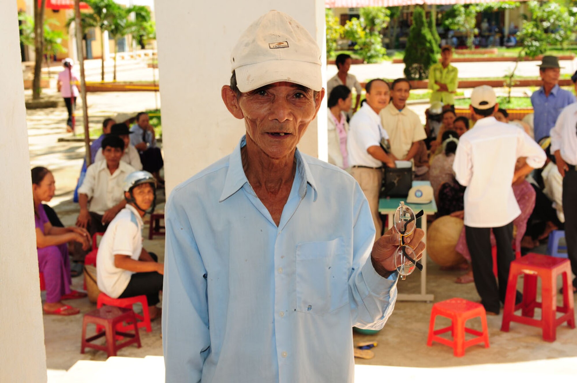 A Vietnamese man shows off his newly prescribed glasses after being cared for Sept. 18 by Air Force medical professionals in Quang Tri Province, Vietnam. U.S. military members are in Vietnam Sept. 15-24 to provide humanitarian assistance in cooperation with local authorities to Quang Tri Province residents. Pacific Angel is a Pacific Air Forces operation led by 13th Air Force at Hickam Air Force Base, Hawaii. The joint and combined humanitarian assistance operation is conducted in the Pacific area of responsibility to support U.S. Pacific Command’s capacity-building efforts. (U.S. Air Force photo/Tech. Sgt. Kerry Jackson)