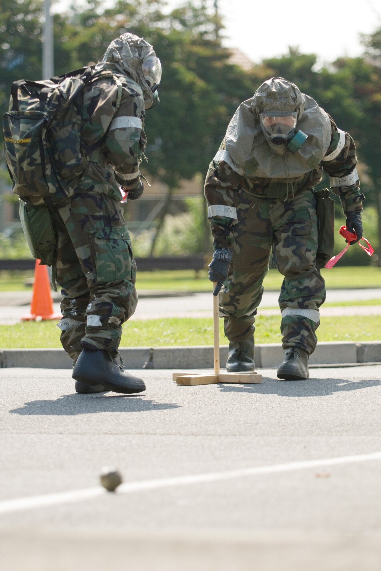 YOKOTA AIR BASE, Japan -- The 374th Security Forces Squadron Post Attack Reconnaissance team sets up an unexploded ordnance cordon during an Ability to Survive and Operate Rodeo PAR team competition Sept. 17 at the Taiyo Community Center. PAR teams from throughout the base went head-to-head to see who was best. The 374th Logistics Readiness Squadron won the competition. The ATSO Rodeo covered areas of emphasis such as contamination control, unexploded ordnance identification and marking and asset protection in a chemical environment. (U.S. Air Force photo/Osakabe Yasuo)

