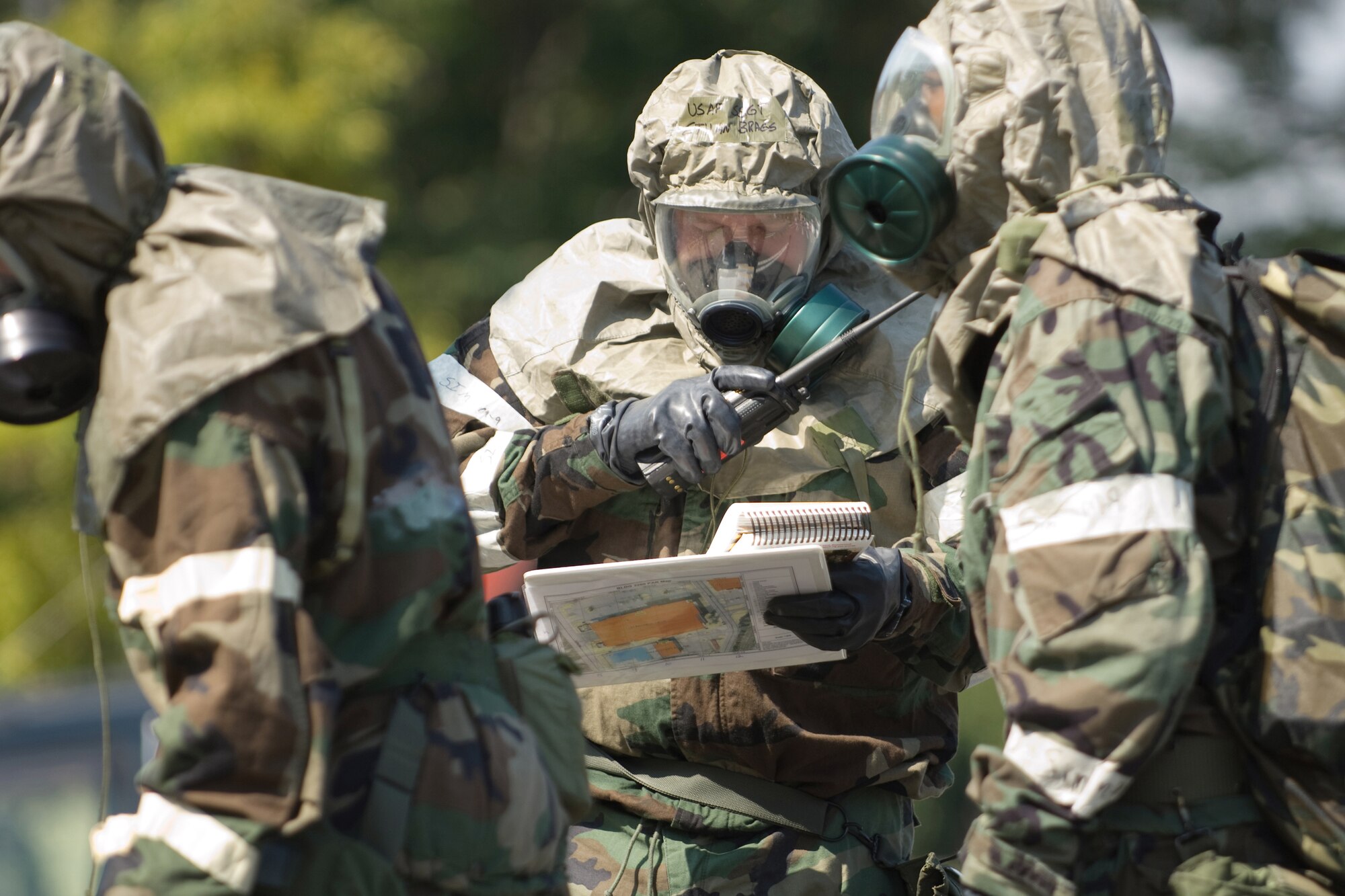 YOKOTA AIR BASE, Japan -- Staff Sgt. Ethan Bragg, 374th Security Forces Squadron, (center) reports a simulated unexploded ordnance to his unit control center during an Ability to Survive and Operate Rodeo PAR team competition Sept. 17 at the Taiyo Community Center. Post attack reconnaissance teams from throughout the base went head-to-head to see who was best. The 374th Logistics Readiness Squadron won the competition. The ATSO Rodeo covered areas of emphasis such as contamination control, unexploded ordnance identification and marking and asset protection in a chemical environment. (U.S. Air Force photo/Osakabe Yasuo)

