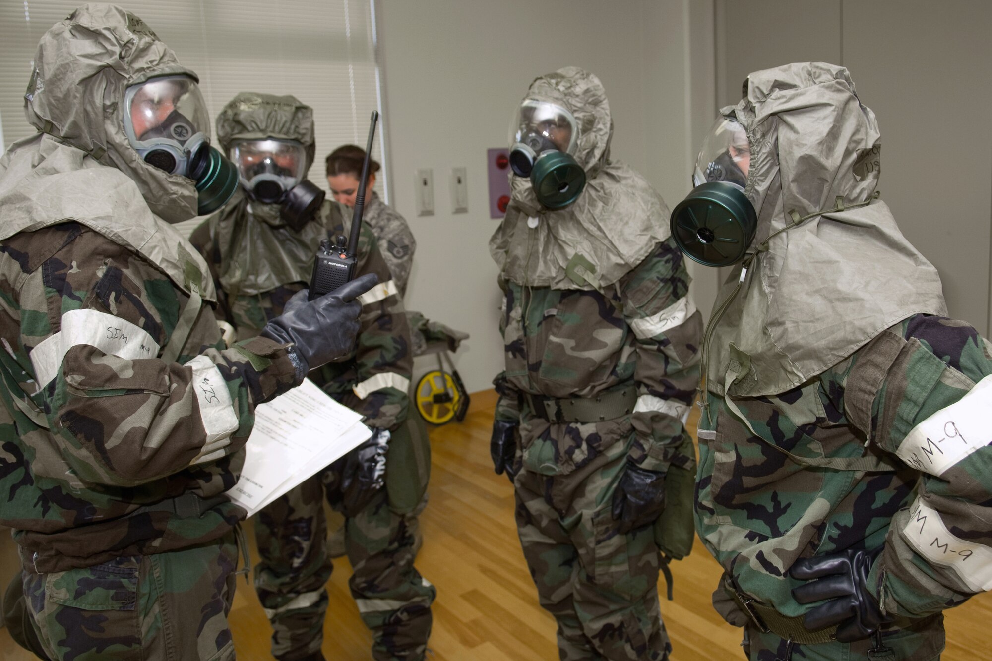 YOKOTA AIR BASE, Japan -- The 374th Security Forces Squadron Post Attack Reconnaissance team gets ready to venture outside during an Ability to Survive and Operate Rodeo PAR team competition Sept. 17 at the Taiyo Community Center. PAR teams from throughout the base went head-to-head to see who was best. The 374th Logistics Readiness Squadron won the competition. The ATSO Rodeo covered areas of emphasis such as contamination control, unexploded ordnance identification and marking and asset protection in a chemical environment. (U.S. Air Force photo/Osakabe Yasuo)

