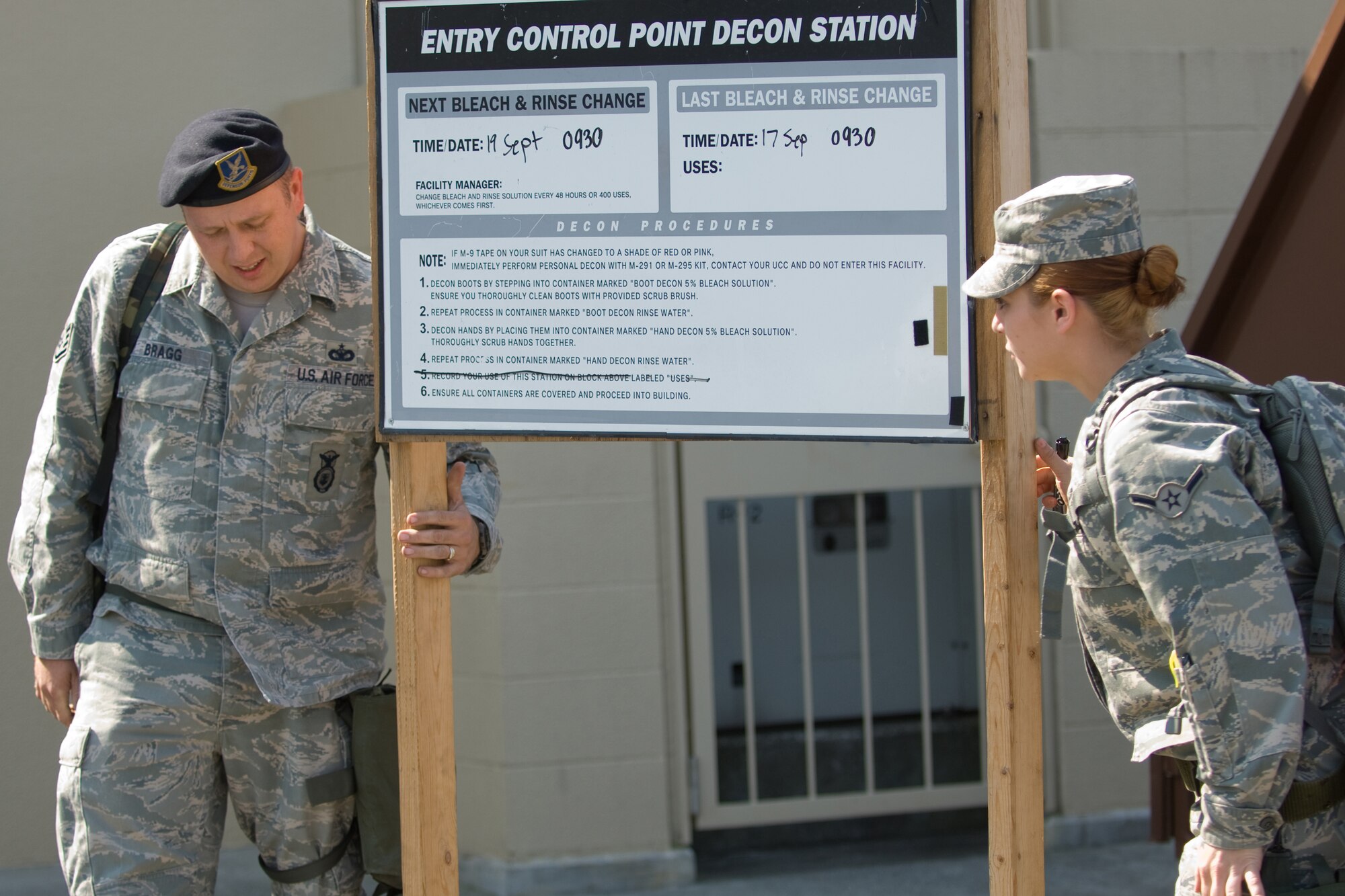 YOKOTA AIR BASE, Japan -- Staff Sgt. Ethan Bragg (left) and Airman Janet Conway, 374th Security Forces Squadron, set up an entry control point decontamination station during an Ability to Survive and Operate Rodeo PAR team competition Sept. 17 at the Taiyo Community Center. Post attack reconnaissance teams from throughout the base went head-to-head to see who was best. The 374th Logistics Readiness Squadron won the competition. The ATSO Rodeo covered areas of emphasis such as contamination control, unexploded ordnance identification and marking and asset protection in a chemical environment. (U.S. Air Force photo/Osakabe Yasuo)
