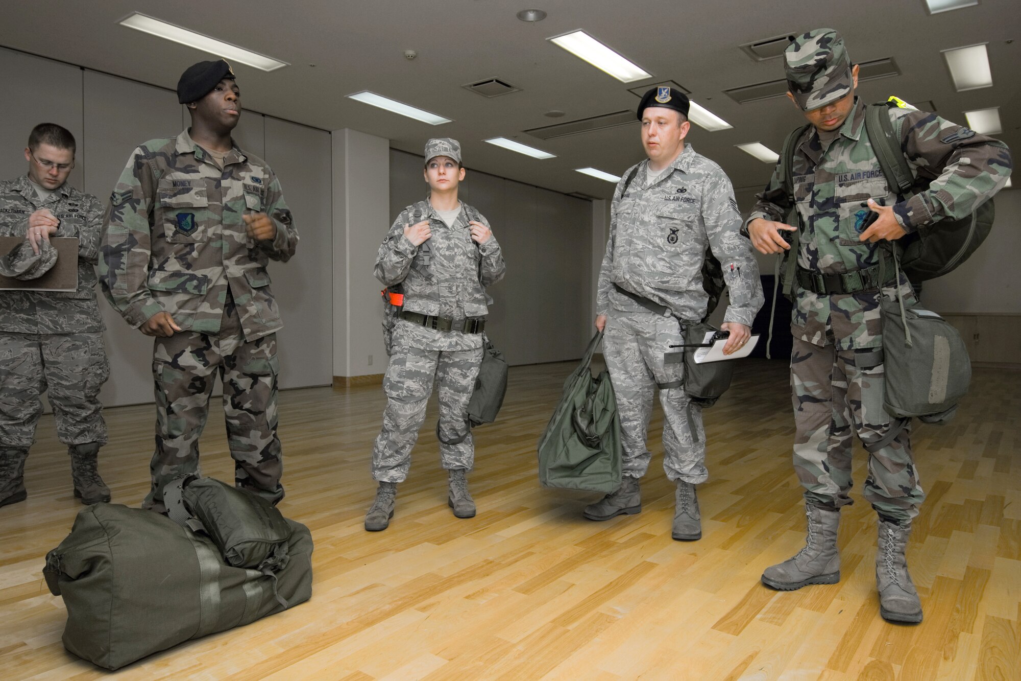 YOKOTA AIR BASE, Japan -- The 374th Security Forces Squadron Post Attack Reconnaissance team prepares for an Ability to Survive and Operate Rodeo PAR team competition Sept. 17 at the Taiyo Community Center. PAR teams from throughout the base went head-to-head to see who was best. The 374th Logistics Readiness Squadron won the competition. The ATSO Rodeo covered areas of emphasis such as contamination control, unexploded ordnance identification and marking and asset protection in a chemical environment. (U.S. Air Force photo/Osakabe Yasuo)
