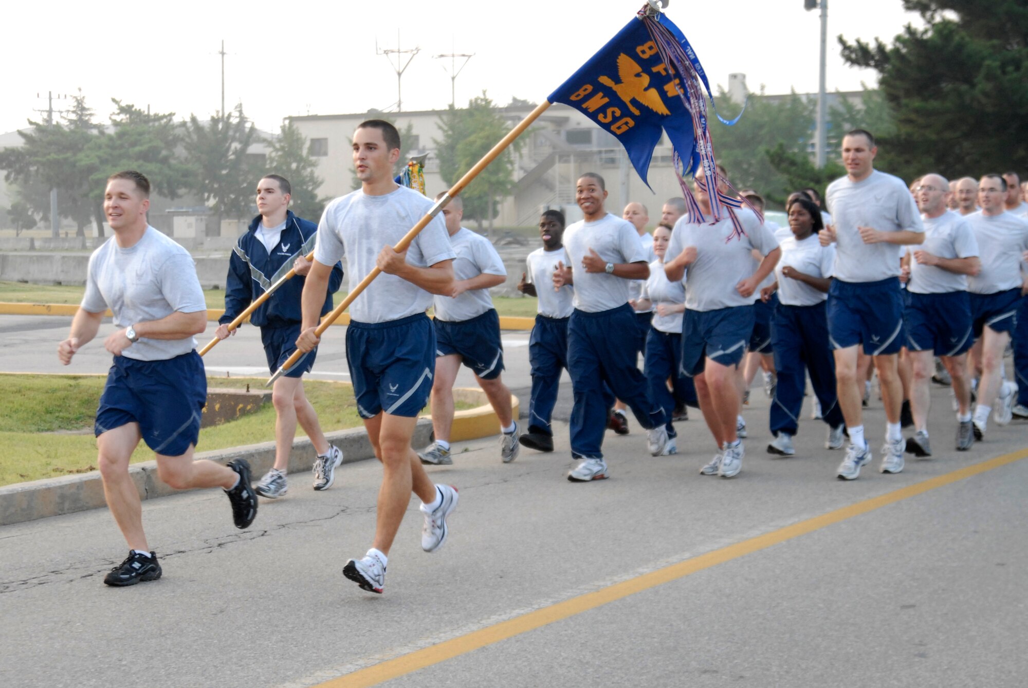 KUNSAN AIR BASE, Republic of Korea -- The 8th Mission Support Group runs behind their lead guidon during the 8th MSG fun run Sept 18. Every squadron within the MSG ran in formation behind their lead guidon for 2.3 miles, stopping in the middle to recite the Airman's Creed. The run was in recognition of the Air Force's 62nd Birthday. (U.S. Air Force photo/Staff Sgt. Darnell T. Cannady)