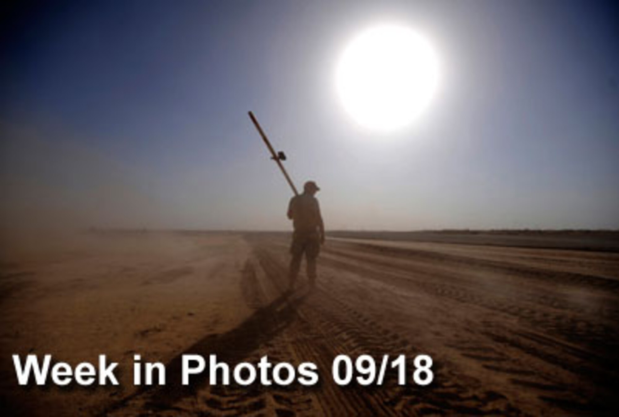 Air Force Week in Photos for Sept.18 highlights photos from around the Air Force. In this photo by Staff Sgt. Shawn Weismiller, Airman 1st Class Davis Smith carries a guide used in airfield construction at Forward Operating Base Dwyer, Afghanistan. (U.S. Air Force photo illustration) 
