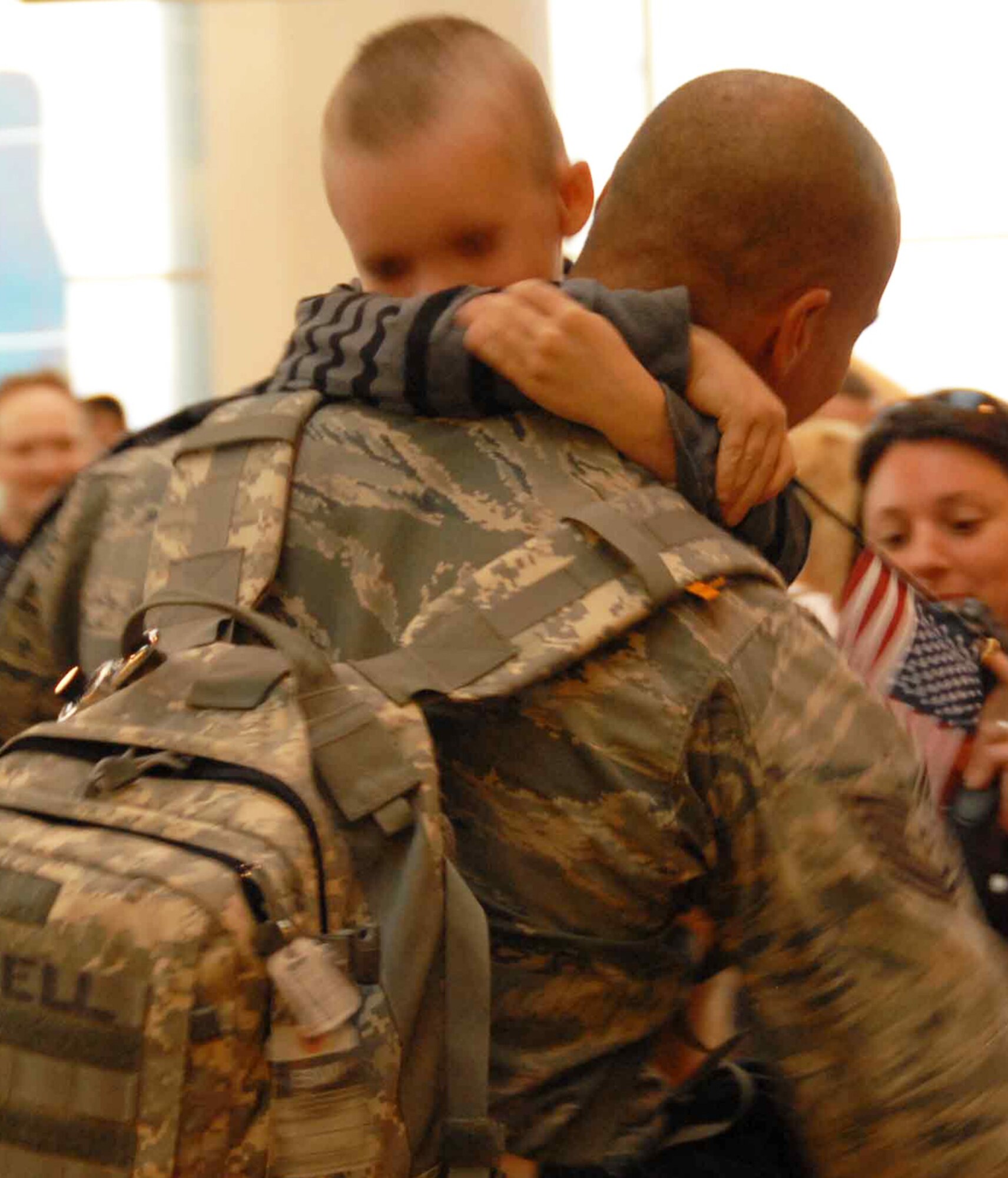 Five-year-old James Fussell hugs his dad, Tech. Sgt. Ted Fussell, tightly to welcome him home Sunday, September 13 from his six month deployment to Iraq.   Tech. Sgt. Fussell is part of the 477th Fighter Group Civil Engineer Squadron and one of the 37 Airmen who deployed to Kirkuk Air Base, Iraq, for the past four to six months. During their deployment, the Airmen worked with other Airmen, soldiers, and Iraqi fliers to repair roads and runway and reconstruct shrines for public use.  The Airmen also helped train and teach local nationals on several construction techniques.  The deployment was the first full unit deployment for the squadron and first for the 477th FG. (Air Force Photo / Tech. Sgt. Craig Dunbar)