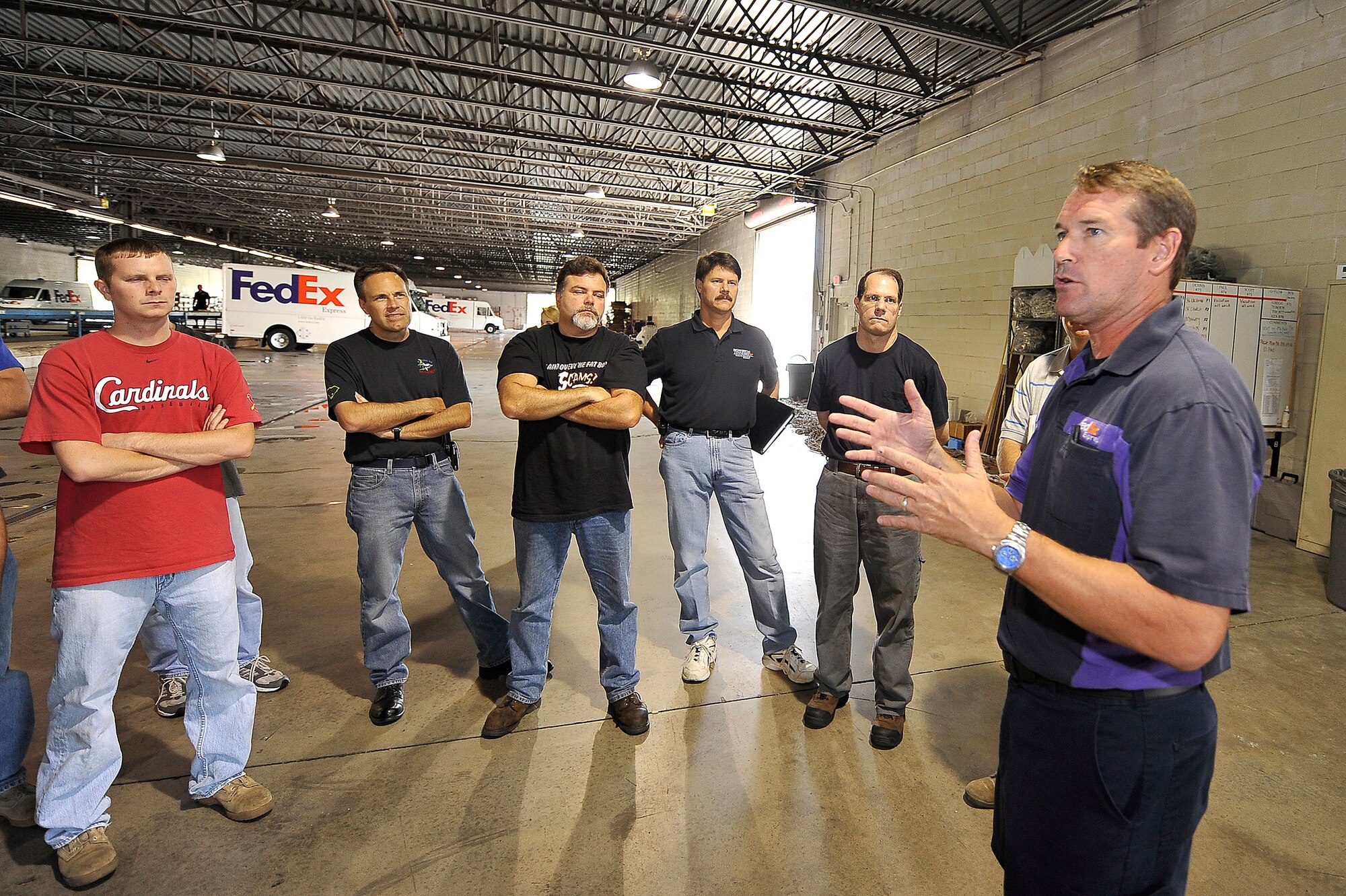 John Devereux gives the 437th Aerial Port Squadron's Lean event team a briefing on daily operations at a FedEx facility Sept. 9, 2009 in North Charleston, S.C. The Lean event team visited the facility as part of an Air Force Smart Operations for the 21st Century initiative to stream line 437th APS workflow. Mr. Devereux is a manager of station operations for FedEx. (U.S. Air Force photo/James M. Bowman)