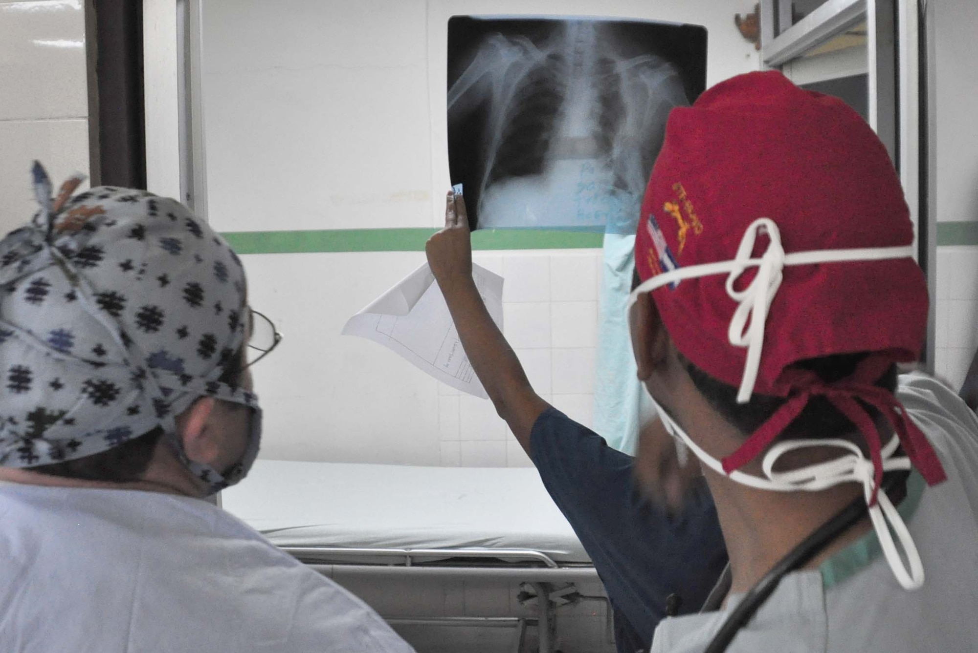 SOTO CANO AIR BASE, Honduras — Dr. Jose Angel Mejia and Dr. Miguel Coello, JTF-Bravo Medical Element liaison officer, examine an X-ray of a patient with a cyst in her neck before the surgery Sept. 16 in Comayagua, Honduras. Dr. Mejia worked alongside a four-person medical team from Joint Task Force-Bravo during a medical readiness training exercise, or MEDRETE. The MEDRETE is used for training purposes for both local doctors and the military team (U.S. Air Force photo/Staff Sgt. Chad Thompson).