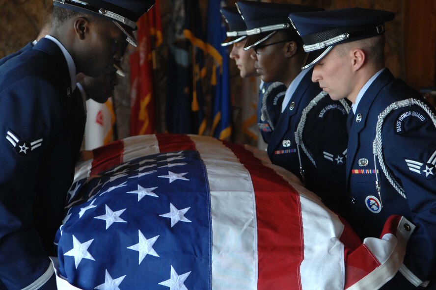 Airmen from Ellsworth Air Force Base Honor Guard set down a coffin that holds a World War ll veteran at Black Hills Cemetery in Rapid City, S.D., Sept. 15. The primary mission of the U.S. Air Force Honor Guard program is to employ, equip and train Air Force members to provide professional military funeral honors for active duty, retired members and veterans of the United States Air Force. (U.S. Air Force photo by Airman 1st Class Corey Hook)