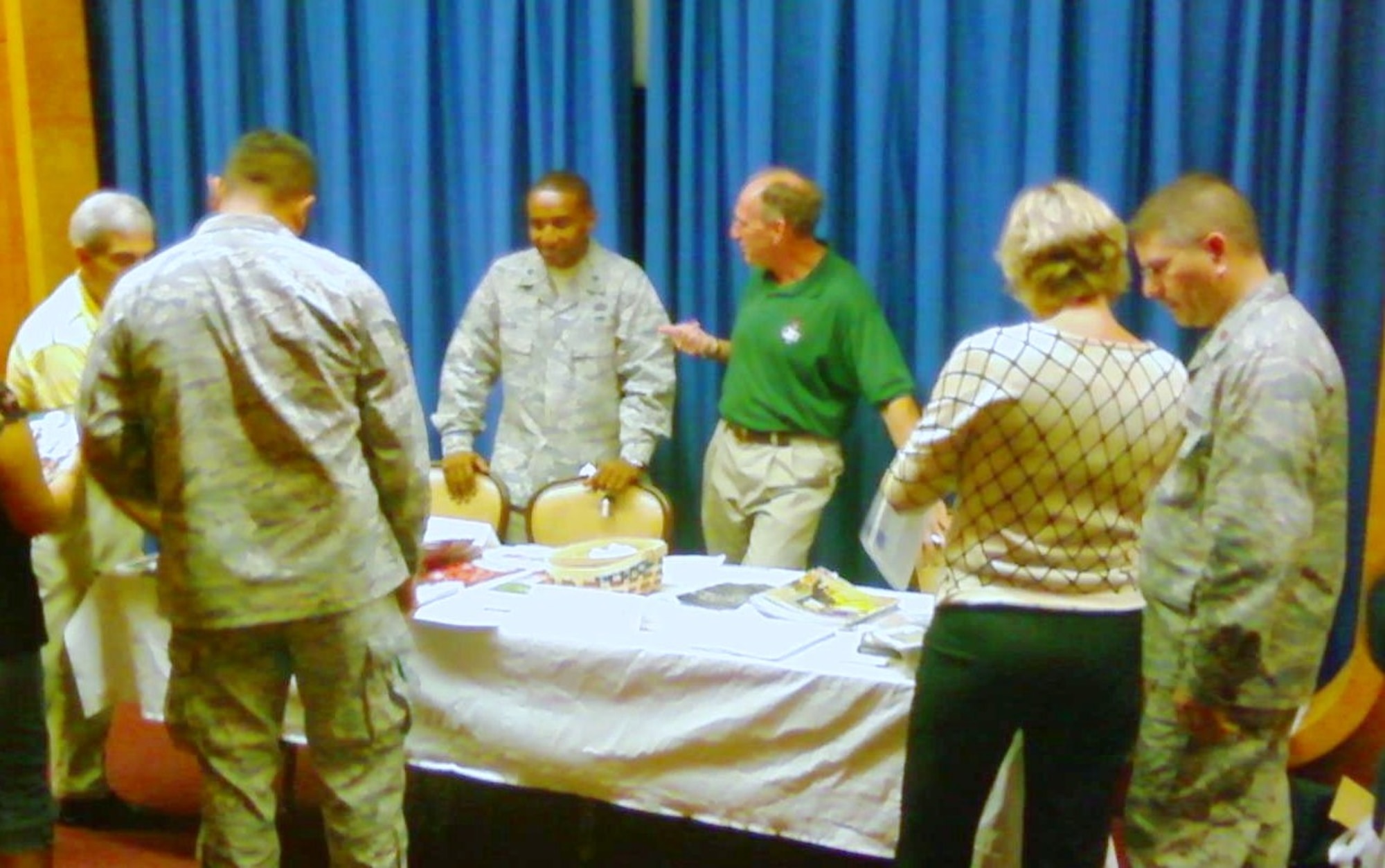 Bert Cream, Dayton Development Coalition, Phil Houston of the Greene County Department of Development and Julee Terilli with Coldwell Banker realtors in Dayton, talk to Airmen from Brooks City-Base about their upcoming transition to Wright-Patterson Air Force Base. (USAF photo)