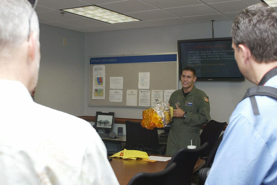 Senior Airman Anthony Toste, loadmaster, 700th Airlift Squadron, demonstrates the use of the emergency oxygen system for visiting employers during a preflight briefing Sept. 12. (U.S. Air Force photo/Mr. Don Peek)