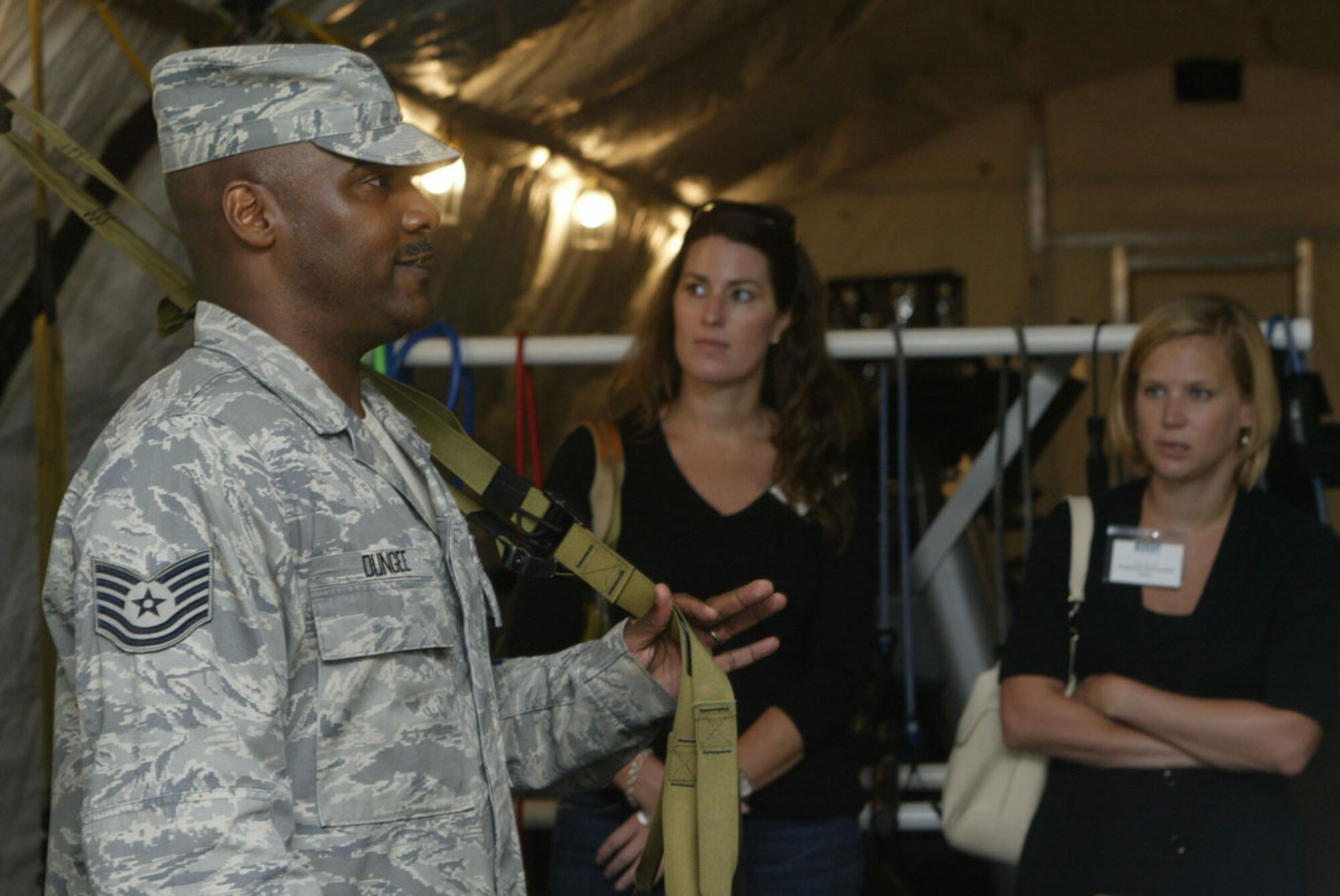 During a tour conducted for a group of employers visiting Dobbins Sept. 12, Tech. Sgt. Jovor L. Dungee from the Air Force Reserve Command Services Training Center demonstrates a piece of fitness apparatus in the fitness center used by students attending the school. (U.S. Air Force photo/Mr. Don Peek)