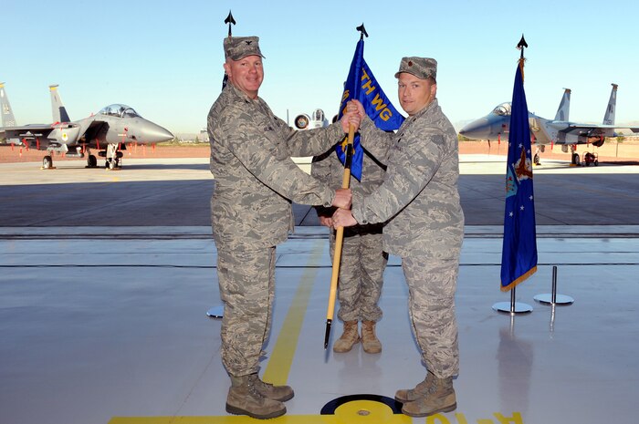 NELLIS AIR FORCE BASE Nev.,-- Col. Dave Blanks, 57th Maintenance Group commander, passes the guidon to Maj. Shane Henderson, the new 757th Aircraft Maintenance Squadron commander, during the 757th AMXS rectivation ceremony at Nellis, Sept. 17. This is the second aircraft maintenance squadron established under the 57th Maintenance Group with the purpose of providing focused aircraft maintenance. (U.S. Air Force photo by Airman 1st Class Brett Clashman)
