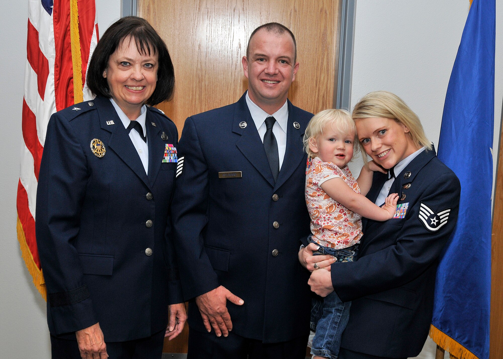 Retired Brig. Gen. Carol Elliott, Tech. Sgt. Benjamin Aylward, his wife Staff Sgt. Melanie Aylward and their daughter Ava, pose for a photo following Sergeant Aylward’s Bronze Star ceremony here Sept 10.