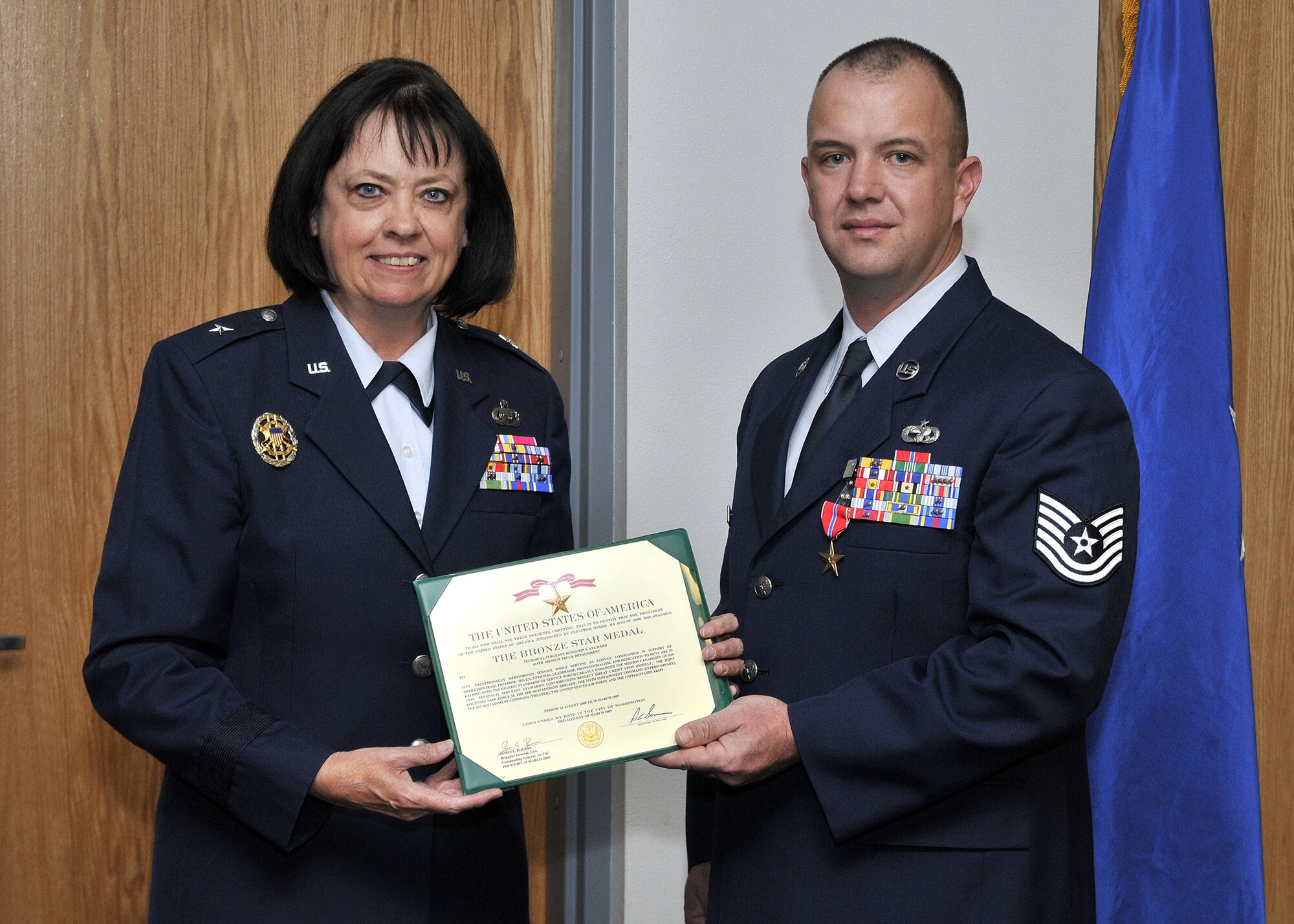Retired Brig. Gen. Carol Elliott presents Tech. Sgt. Benjamin Aylward, 341st Logistics Readiness Squadron, with the Bronze Star Medal during a ceremony held here Sep. 10. (U.S. Air Force photo/John Turner)