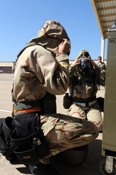 WHITEMAN AIR FORCE BASE, Mo. – Members of the 442nd Fighter Wing inspect each other after donning their gas mask during the Phase II exercise, Sept. 16. Phase II exercise is an annual mobility exercise, which inspects all areas of 442nd operations. (U.S. Air Force photo/Senior Airman Cory Todd)