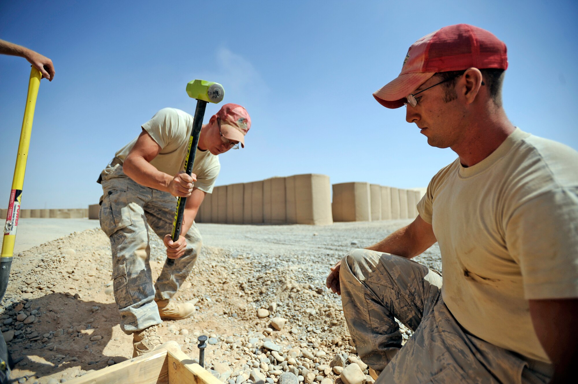 Staff Sgt. Johnathon Stone (left) and Staff Sgt. Daniel Berner hammer down stake for a cement pad Sept. 9, 2009 at Forward Operating Base Dwyer, Afghanistan. Staff Sgt. Stone and Staff Sgt. Berner are deployed from the 819th Red Horse Squadron, Malmstrom, AFB, MT These Airmen are assigned to the 809th Expeditionary Red Horse Squadron, 1st Expeditionary Red Horse Group. (U.S. Air Force Photo/Staff Sgt. Shawn Weismiller)