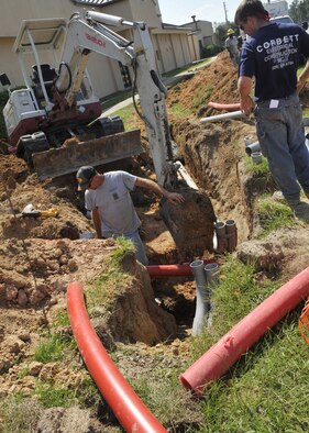 MOODY AIR FORCE BASE, Ga. -- Contract workers participate in a construction project to install underground electrical duct lines around Moody here Sept. 9. The purpose of the project is to transition the overhead power lines to underground power lines throughout the base. (U.S. Air Force photo by Senior Airman Schelli Jones) 