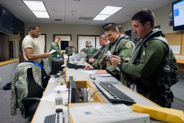KUNSAN AIR BASE, Republic of Korea -- F-16 pilots with the 35th Fighter Squadron finish up pre-flight paperwork Sept. 18. The 35th FS heads to Eielson Air Force Base for Distant Frontier and Red Flag Alaska for month-long training. Distant Frontier gives the Wolf Pack team the chance to drop live and inert heavyweight munitions. Red Flag Alaska gives the pilots and maintainers an air combat training environment where multi-services, multi-platforms and their aircrews are run through every thinkable combat threat. (U.S. Air Force photo/Senior Airman Jonathan Steffen)