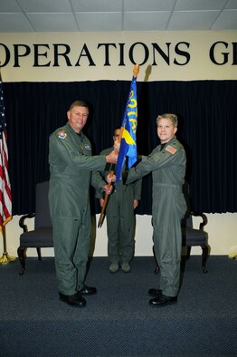 Colonel Douglas Schwartz, 927th Operations Group commander, passes the 927th Operations Support Flight flag to Lieutenant Colonel Erich Novak during an Assumption of Command ceremony Saturday (U.S. Air Force Photo/Capt. Shane Huff)