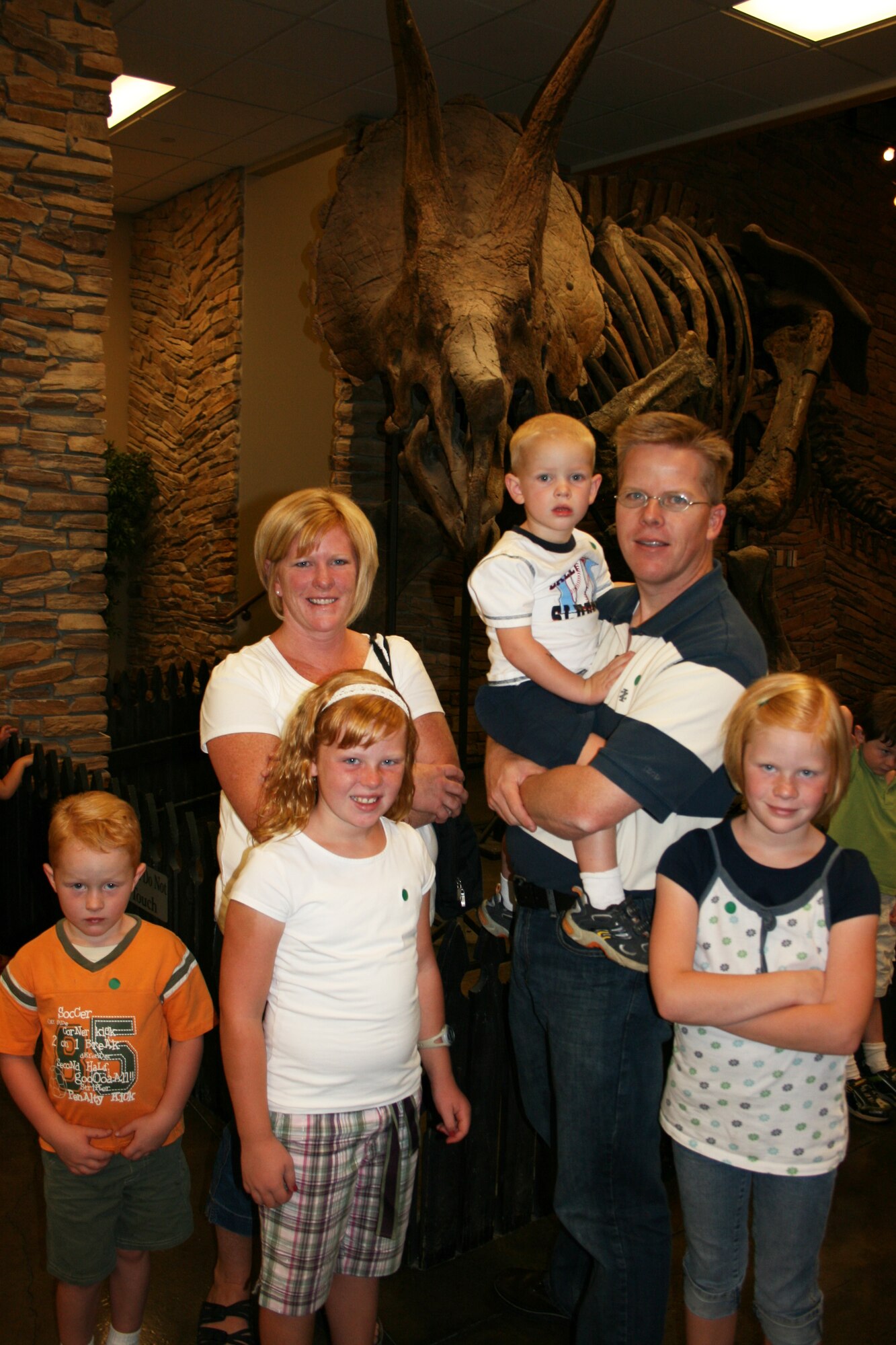 LEHI, Utah ? Master Sgt. Jeff Gustafson, 191st Air Refueling Squadron, and his wife Kristine pose with their family at the Museum of Ancient Life at Thanksgiving Point.  Sergeant Gustafson visited the museum as part of a free opportunity offered through Operation Military Kids this summer.  In Utah, OMK offers children and youth of all the military branches many opportunities for support and recreation. 