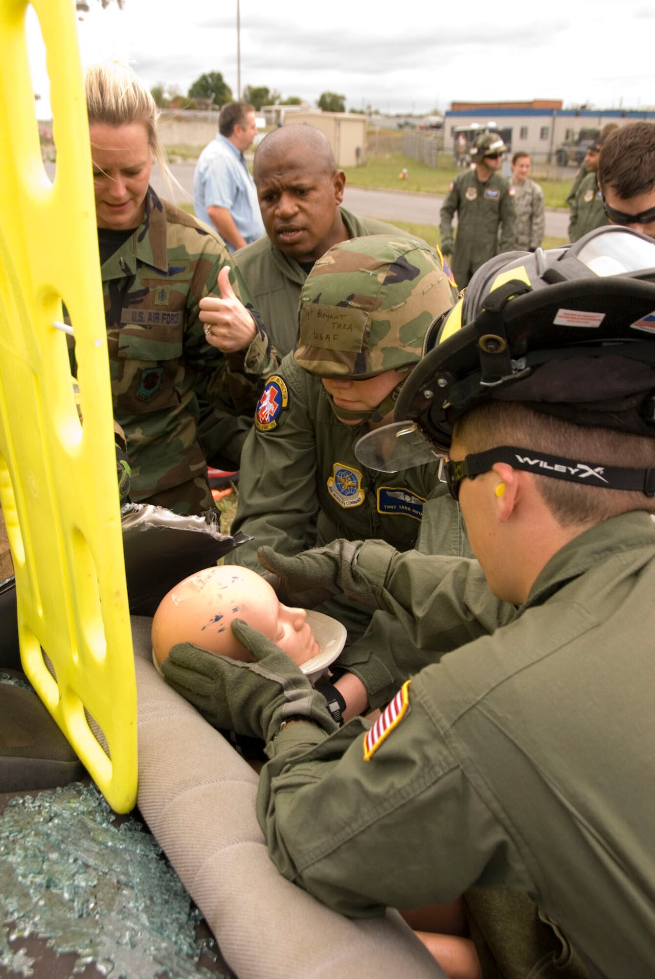 Tech. Sgt. Mary Ann Smith, Master Sgt. Peppy Smith, Tech. Sgt. Tara Bryant, and Airman First Class Jack Messner, all members of  the 167th Aeromedical Evacuation Squadron, prepare to move a dummy, posing as a car crash victim, to a stretcher during a training exercise at the 167th Airlift Wing, Martinsburg West Virginia, September 12, 2009. (U.S. Air Force photo  by Master Sgt Sean Brennan)
