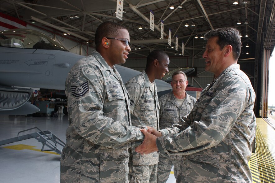 Maj. Gen. Frank Padilla, 10th Air Force commander, presents a commander's coin to Tech. Sgt. Desmond Allen, 482nd Maintenance Squadron, during a visit to Homestead Air Reserve Base on Sept. 12-13. (U.S. Air Force photo/Senior Airman Katie Spencer) 