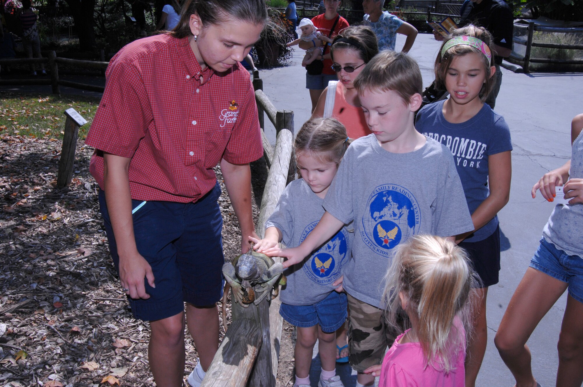 SCOTT AIR FORCE BASE, Ill -- Katelyn and Joshua Daniels, children of Staff Sgts. Mark and Beverly Daniels who are both deployed, recieve a hands-on learning experience with an iguana at Grant's Farm in St. Louis, Mo. Both were there through the Hearts Apart program. Upon returning to Scott, families of deployed members were treated to an ice cream social. 

(U.S. Air Force photo/Airman 1st Class Amber Kelly-Herard)
