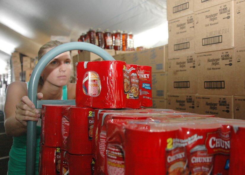 Amanda Henning pushes a cart of items to be sold at the commissary's case lot sale Sept. 17 at Eglin.  The sale runs Sept. 18-20 from 9 a.m. to 5 p.m. in the commissary parking lot.  (U.S. Air Force photo/Airman 1st Class Chris Jacobs.) 