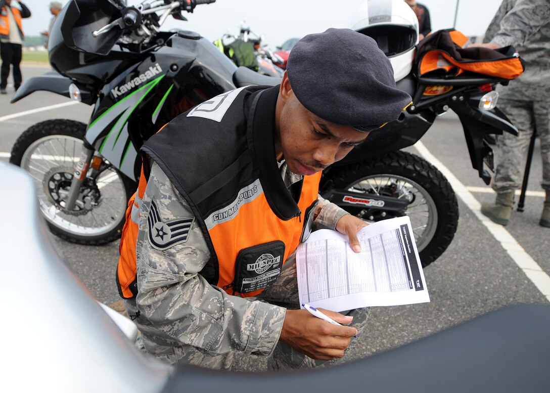 LANGLEY AIR FORCE BASE, Va. -- Staff Sgt. Marvin Kelker, 1st Security Forces Squadron, inspects a motorcycle before Langley's first Air Force Birthday Motorcycle Ride here Sept. 16. All proceeds from the ride were donated to Operation Warm Heart, a year-round program designed to assist Airmen and their families.  (U.S. Air Force photo/Airman Rebecca Montez)