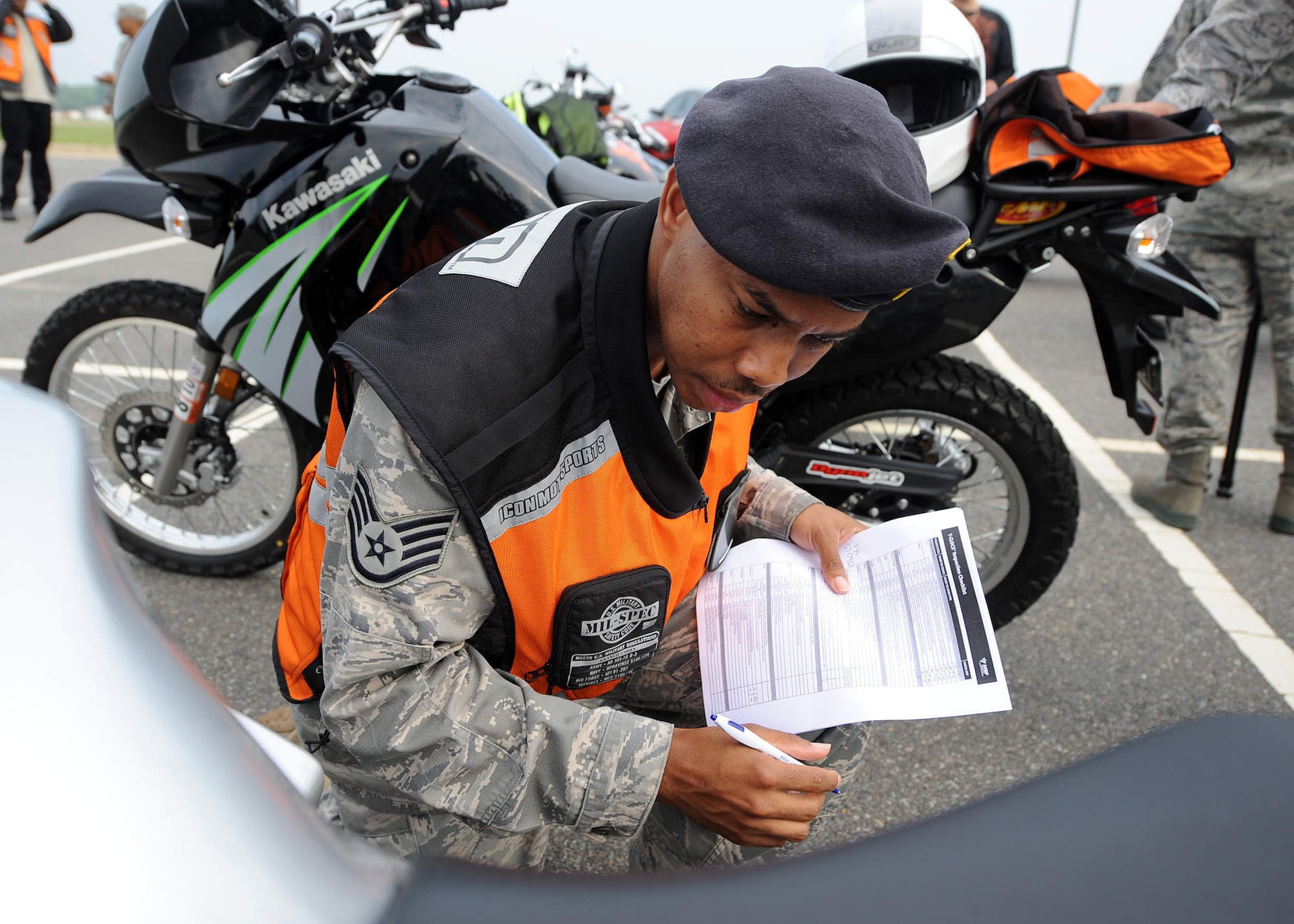 LANGLEY AIR FORCE BASE, Va. -- Staff Sgt. Marvin Kelker, 1st Security Forces Squadron, inspects a motorcycle before Langley's first Air Force Birthday Motorcycle Ride here Sept. 16. All proceeds from the ride were donated to Operation Warm Heart, a year-round program designed to assist Airmen and their families.  (U.S. Air Force photo/Airman Rebecca Montez)