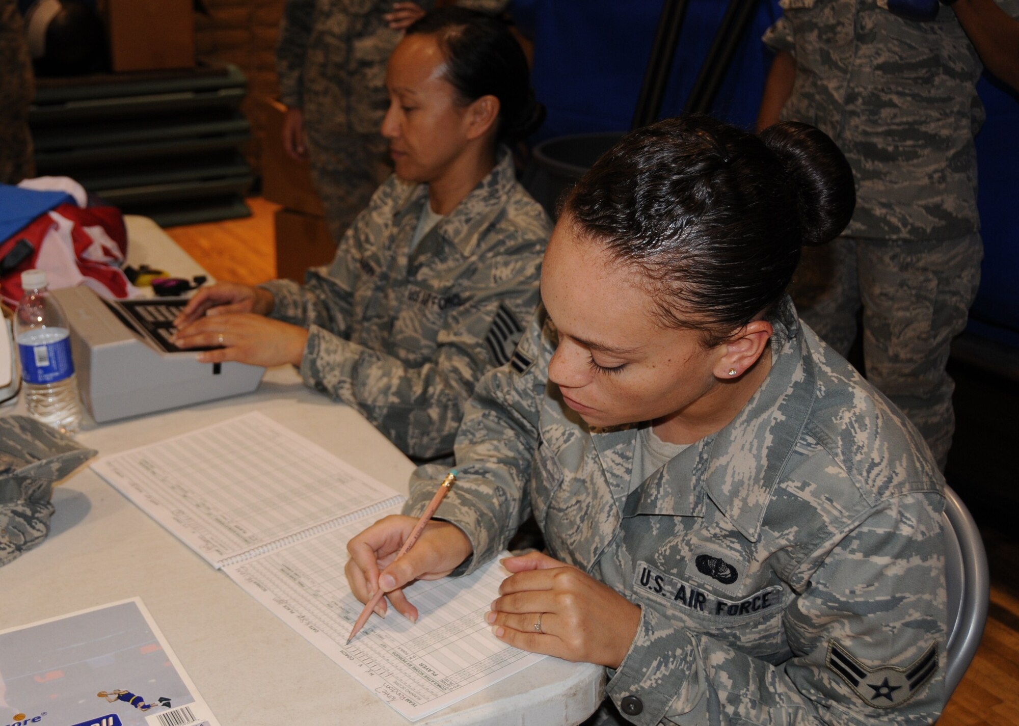 Airman 1st Class Kyla Levy, 944th Services Squadron, keeps score during a 3-on-3 basketball tournament Sept. 16 at the base fitness center. The 944th SVF put on the tournament for wing members during the mandatory home station annual tour to encourage fitness and camaraderie. (U.S. Air Force photo/Tech. Sgt. Susan Stout) 
