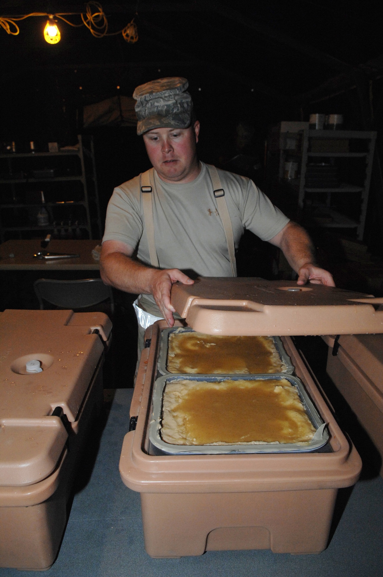 MINOT AIR FORCE BASE, N.D. -- Tech. Sgt. Fred Nordstrom, 5th Force Support Squadron chef, checks the temperature of mash potatoes and gravy in preparation of a midnight meal during combat operations at Base X here Sept. 9. (U.S. Air Force Photo by Staff Sgt. Miguel Lara)