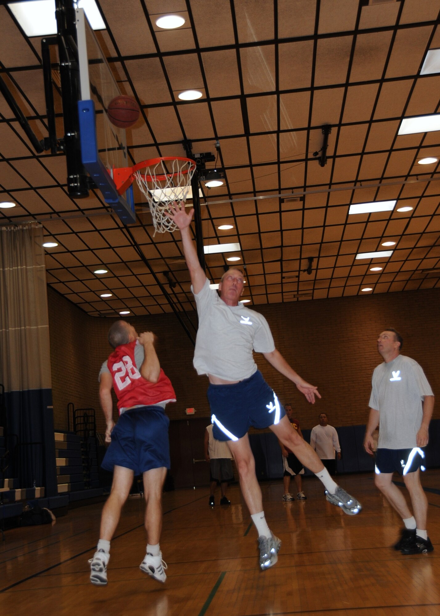 Ed O'Brien, 944th Aeromedical Staging Squadron first sergeant, shoots a basket during a 3-on-3 basketball tournament at the base fitness center Sept. 16. The 944th Services Flight put on a tournament for wing members during the mandatory home station annual tour to encourage fitness and camaraderie. (U.S. Air Force photo/Tech. Sgt. Susan Stout) 