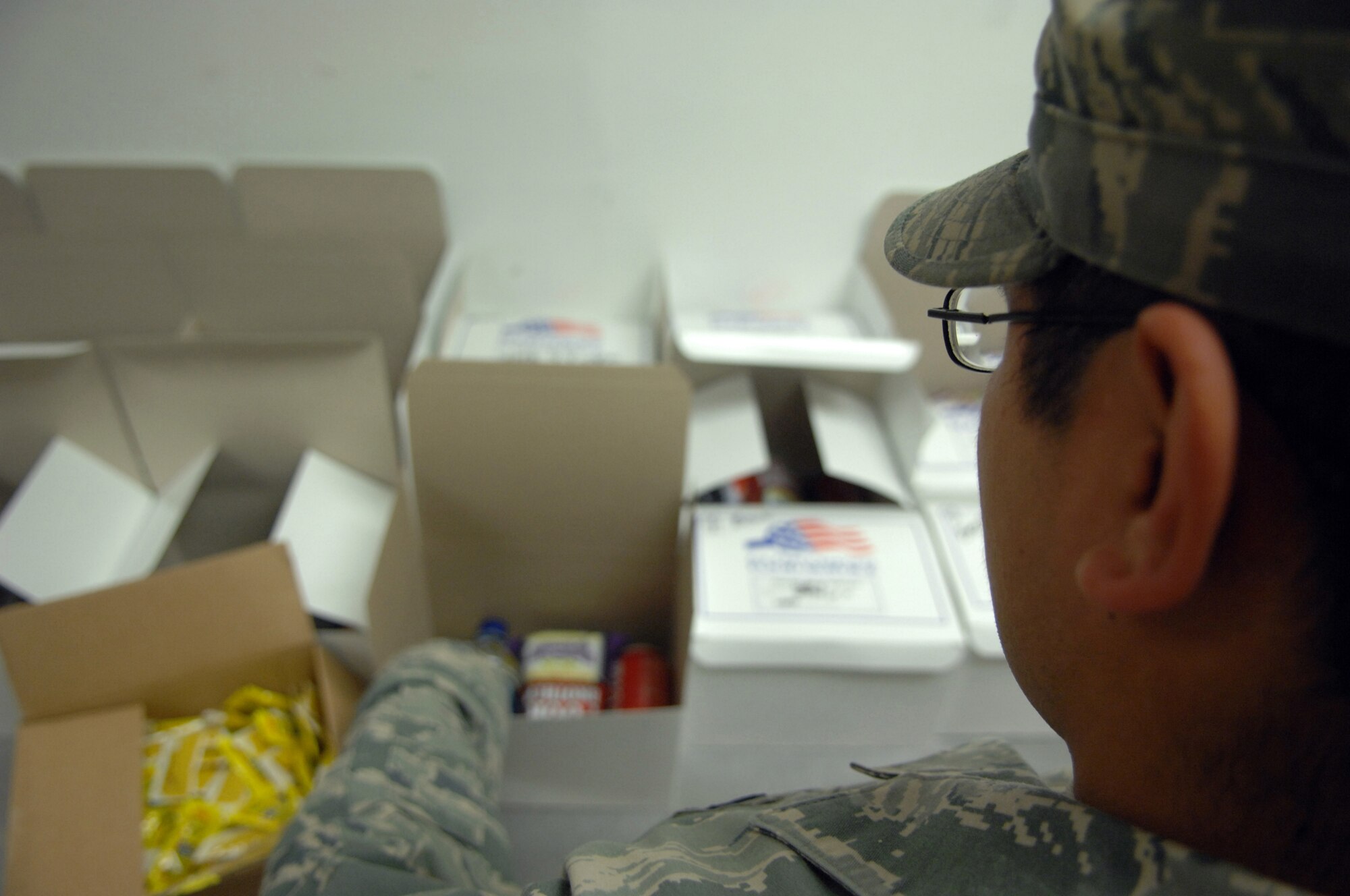 MINOT AIR FORCE BASE, N.D. -- Senior Airman Manuel Raymundo, 5th Force Support Squadron assistant manager of the flight kitchen, prepares boxed lunches during the night shift for Base X personnel Sept. 9 here. (U.S. Air Force Photo by Staff Sgt. Miguel Lara)